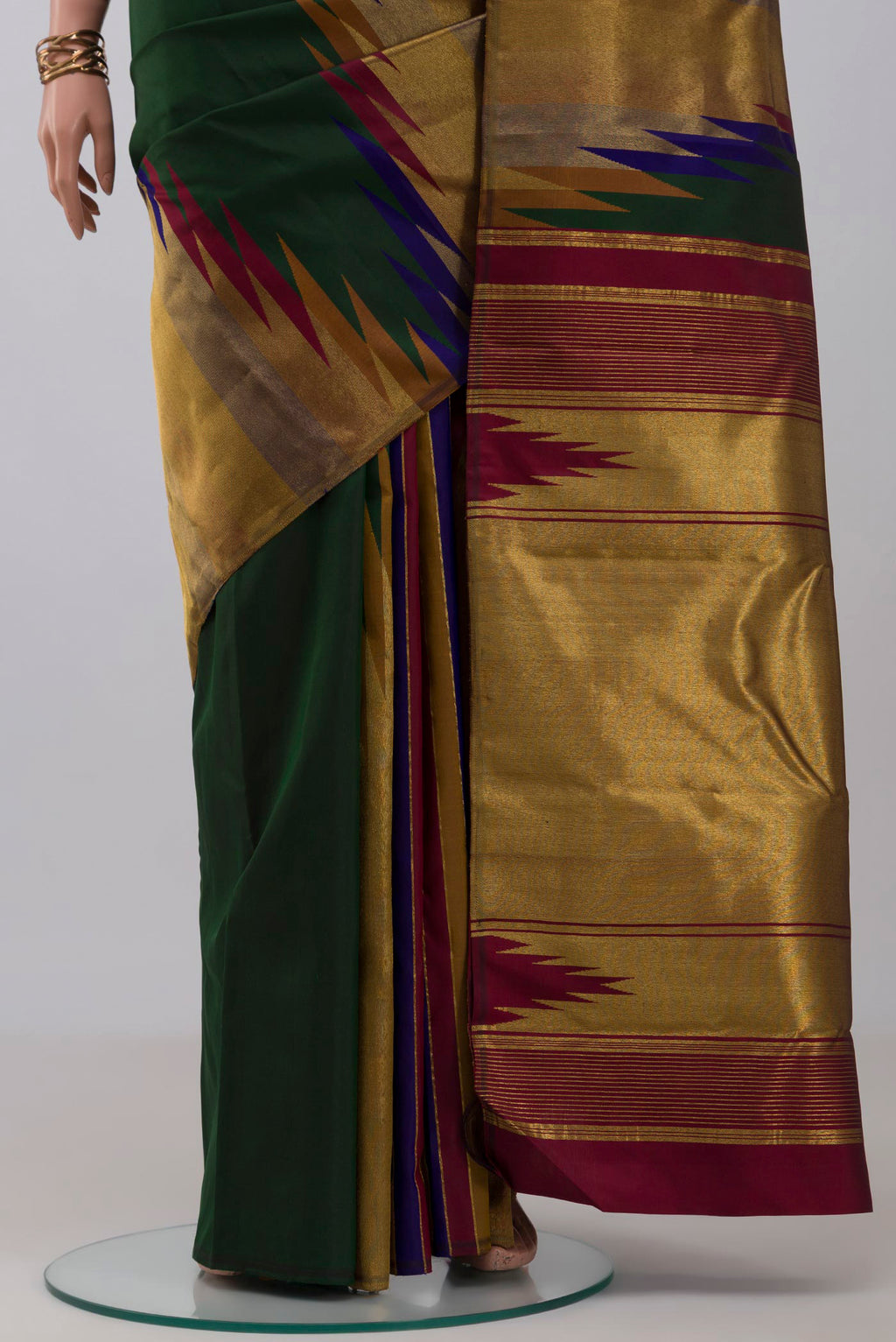 Pleats and pallu of Bottle Green Kanchipuram Silk Saree with Plain Body and Temple Border. 