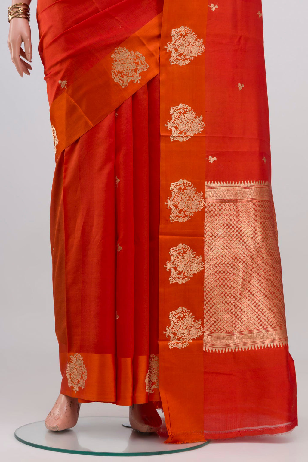 Pleats and pallu of Orange Banarasi Katan Silk Saree with Zari Butta on the body and Zari Border. 