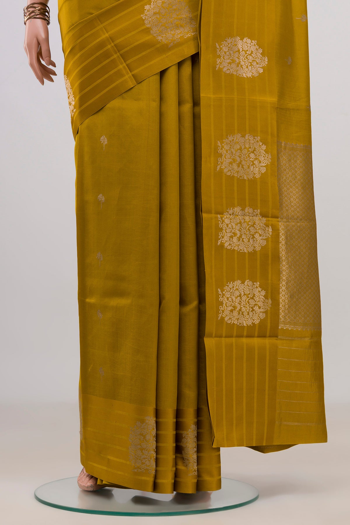 Pleats and pallu of Pure Silk Mustard Banarasi Katan Saree with Zari Butta on the body and Fancy Border. 