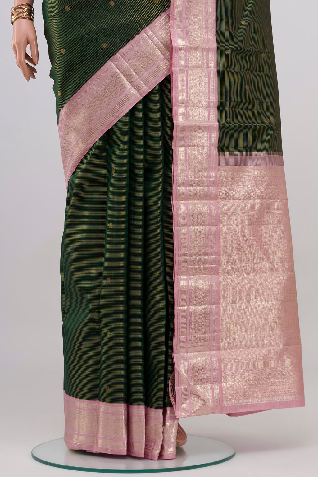 Pleats and pallu of Bottle Green Kanchipuram Silk Saree with Zari Butta on the body and Zari Border. 
