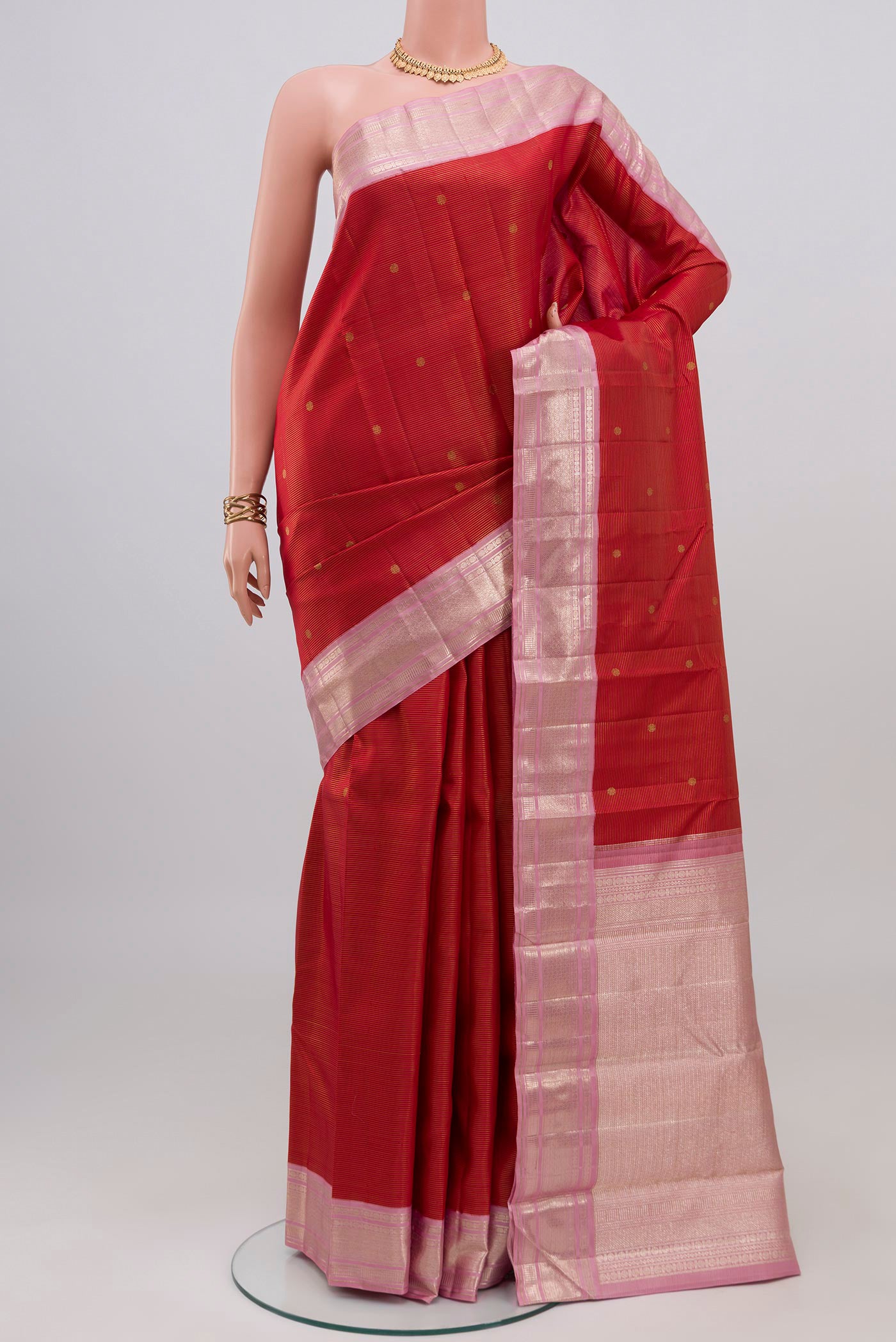 Red Kanchipuram Silk Saree with Zari Butta on the body and Zari Border.  displayed on a mannequin