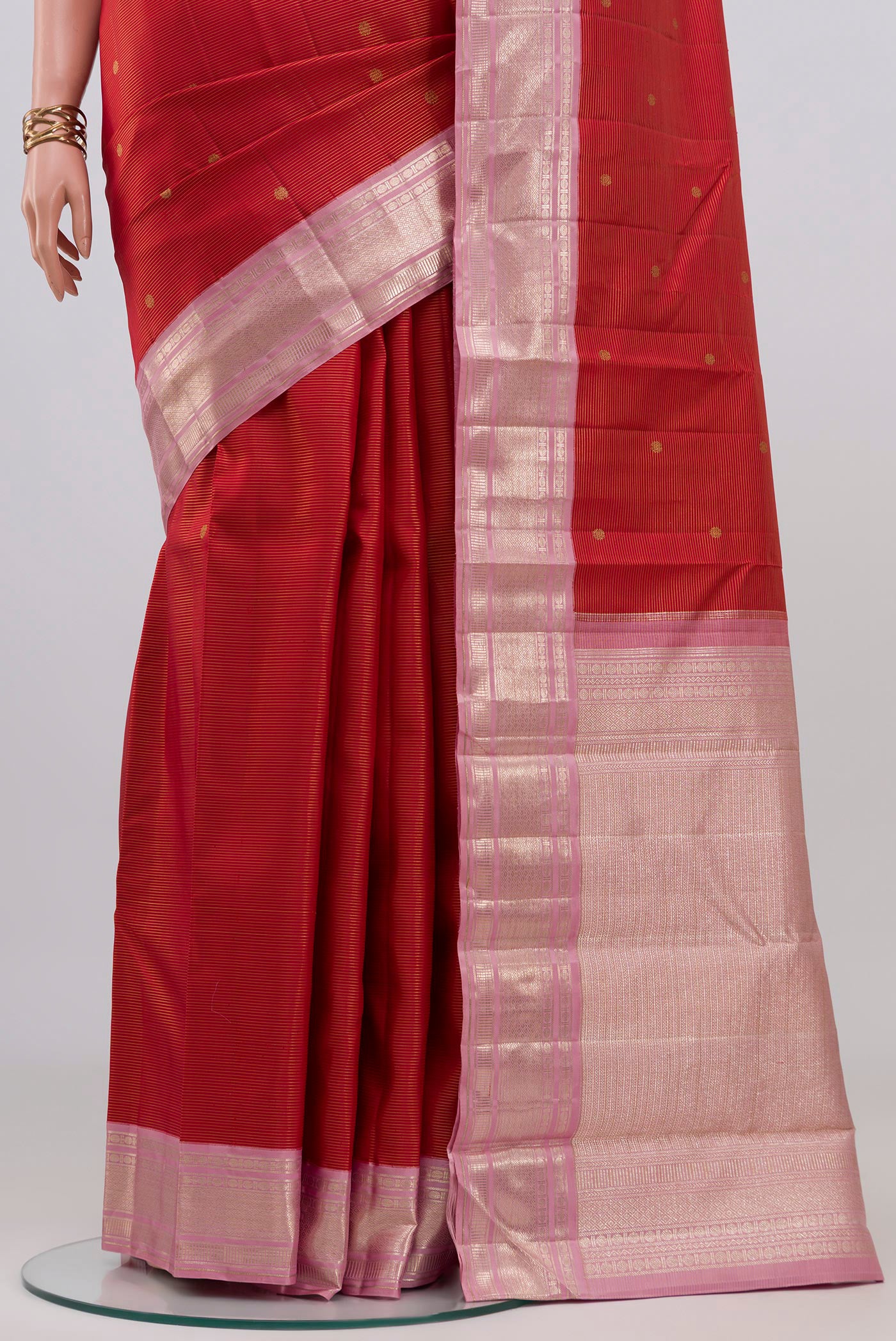 Pleats and pallu of Red Kanchipuram Silk Saree with Zari Butta on the body and Zari Border. 