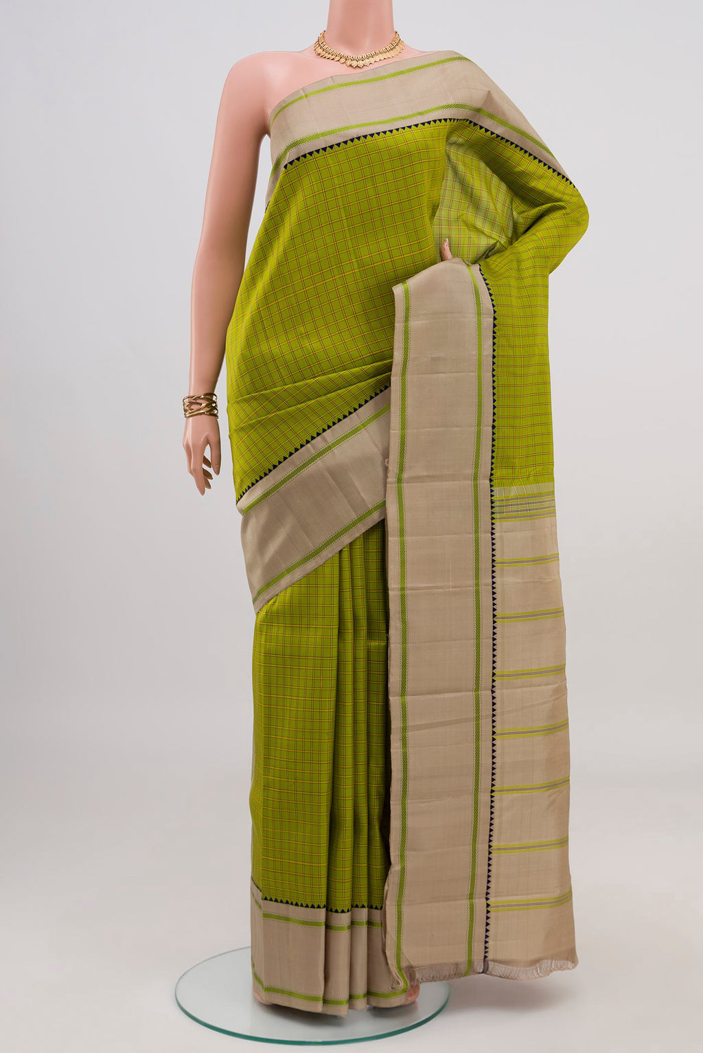 Green Kanjivaram Silk Saree with Checked design on the body and Thread Border.  displayed on a mannequin