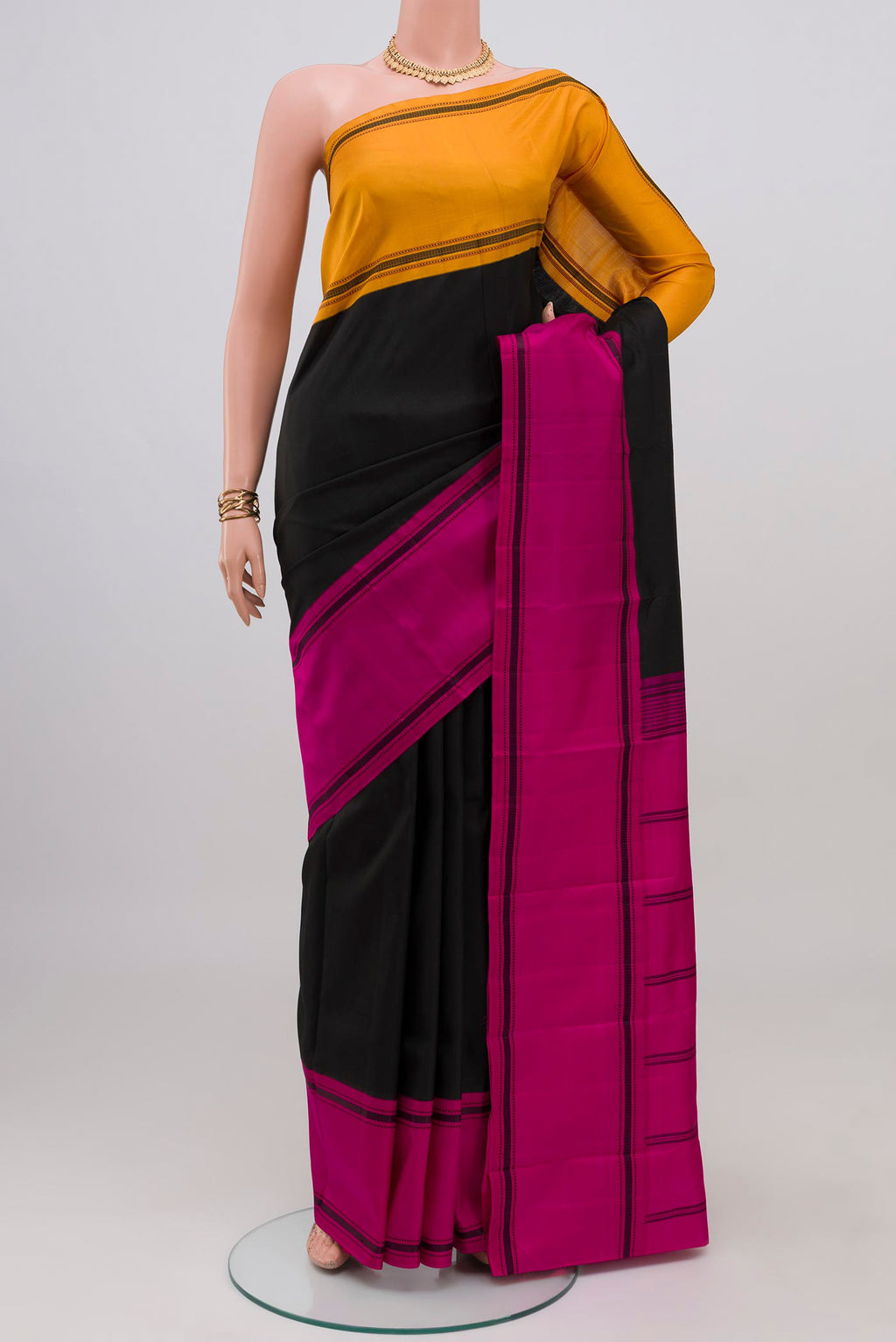 Black Kanchipuram Silk Saree with Plain Body and Ganga Jamuna Border.  displayed on a mannequin
