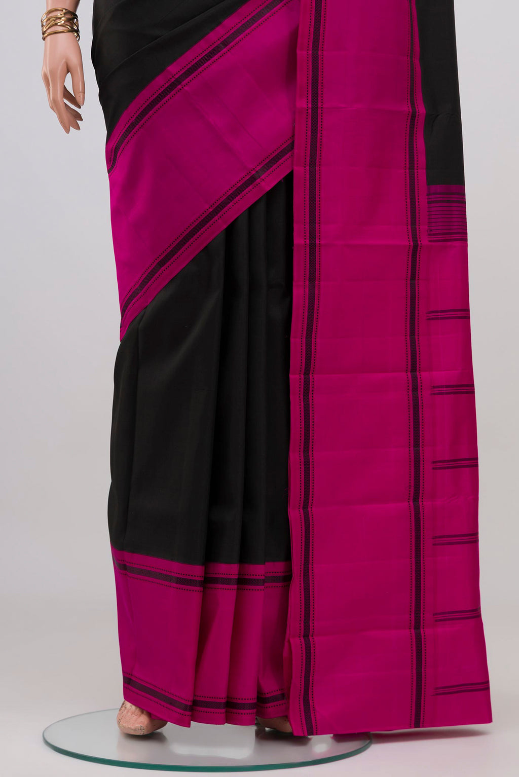 Pleats and pallu of Black Kanchipuram Silk Saree with Plain Body and Ganga Jamuna Border. 