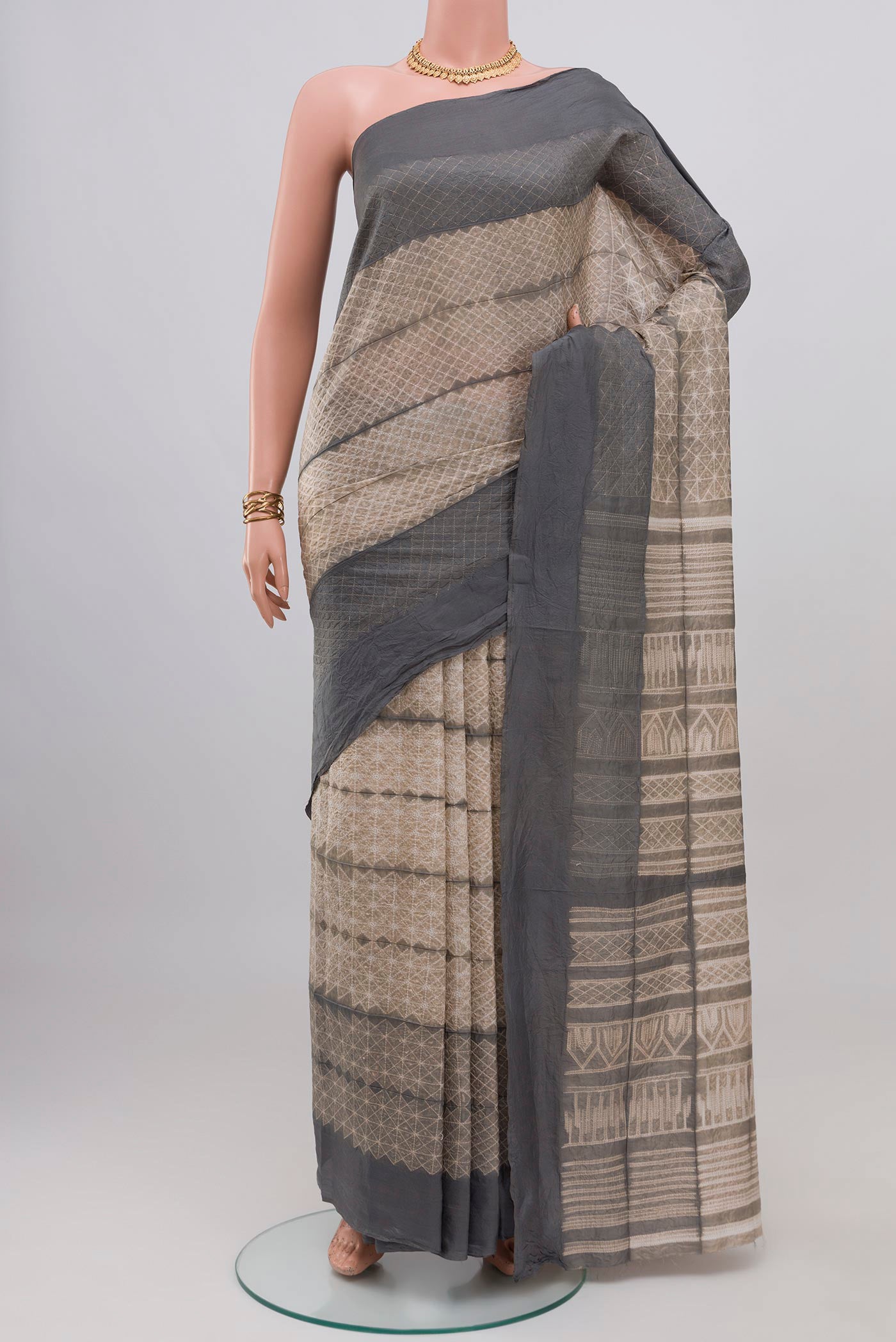 Beige Tussar Silk Saree with Printed design on the body and Plain Border.  displayed on a mannequin