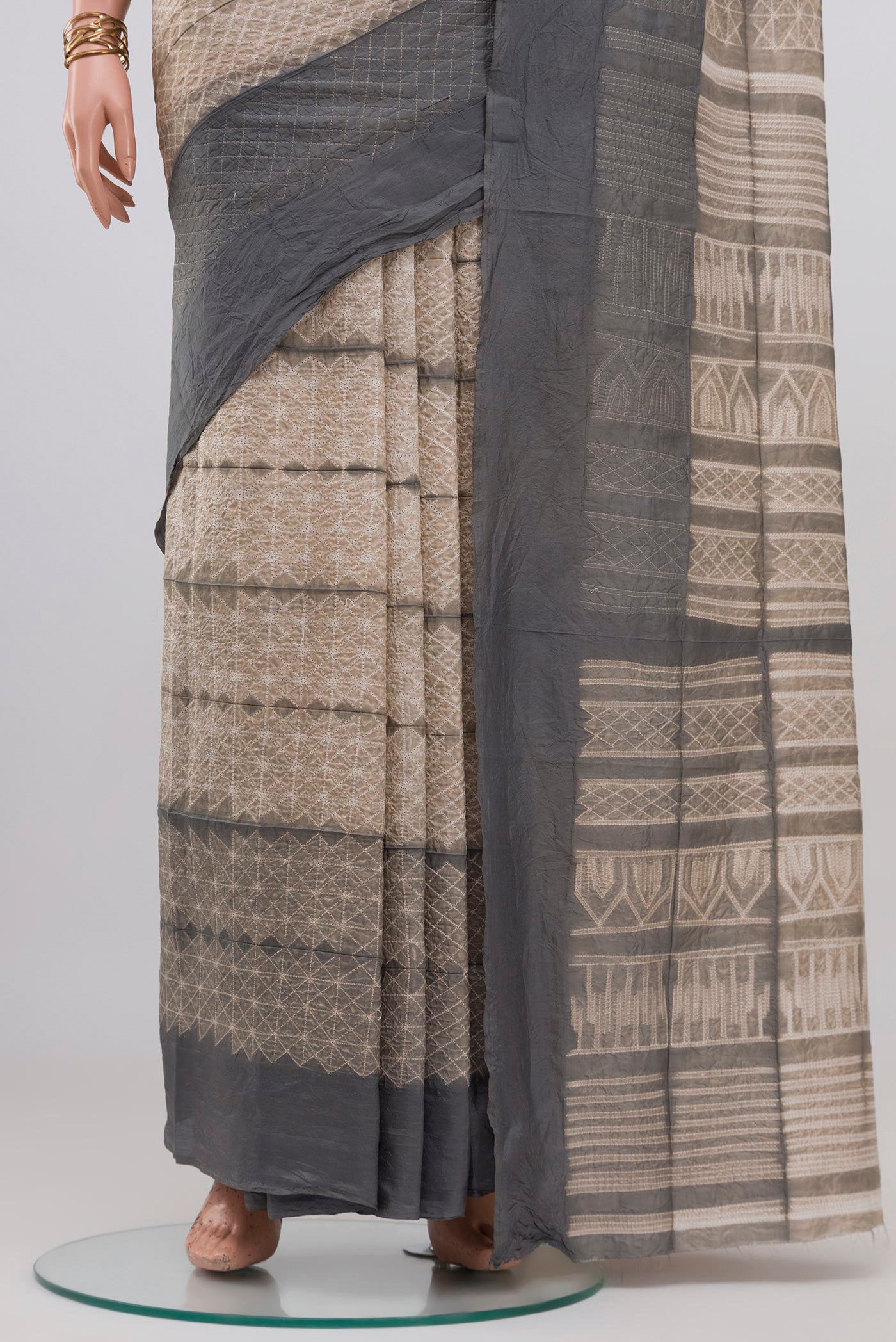 Pleats and pallu of Beige Tussar Silk Saree with Printed design on the body and Plain Border. 