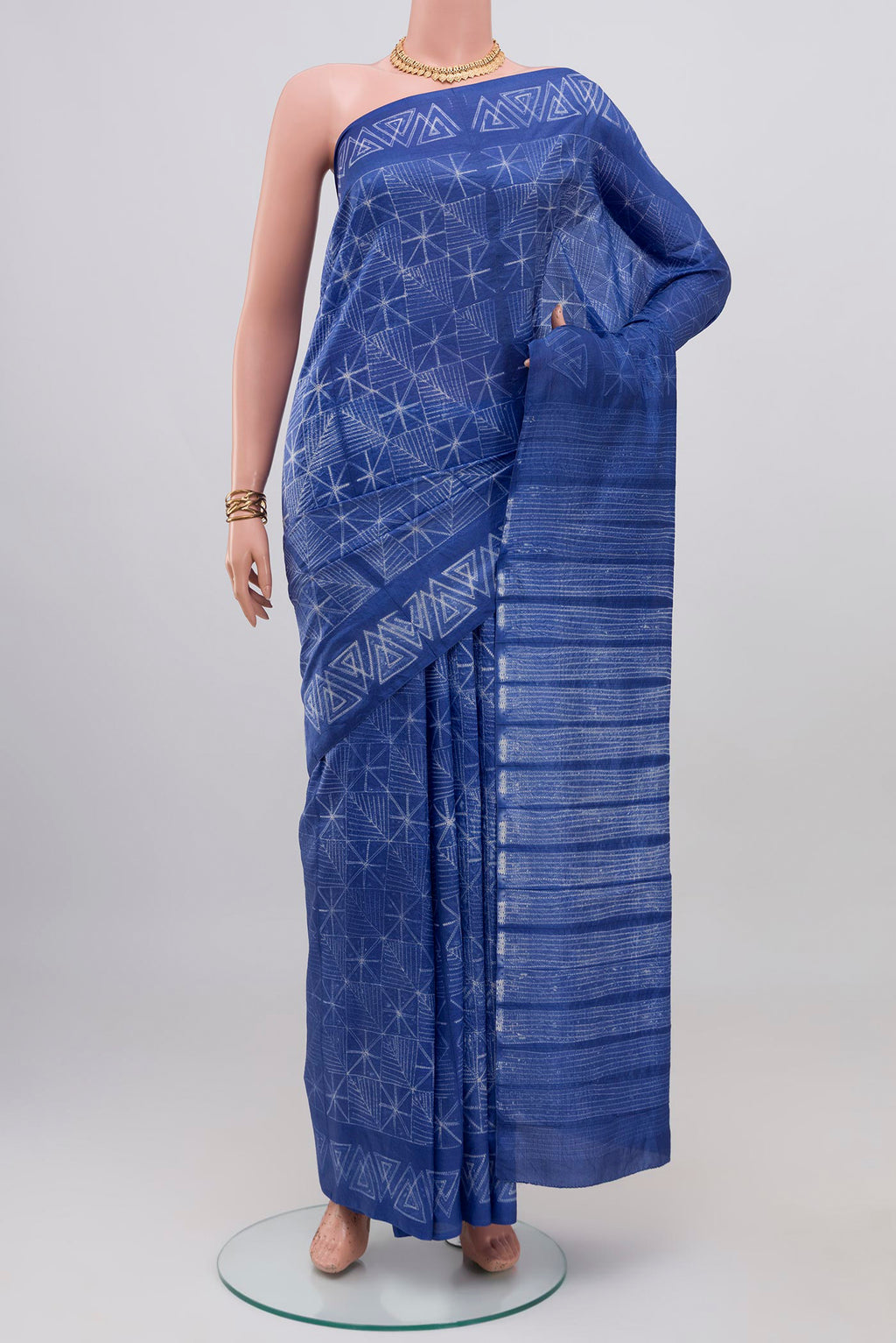 Royal Blue Tussar Silk Saree with Printed design on the body and Printed Border.  displayed on a mannequin