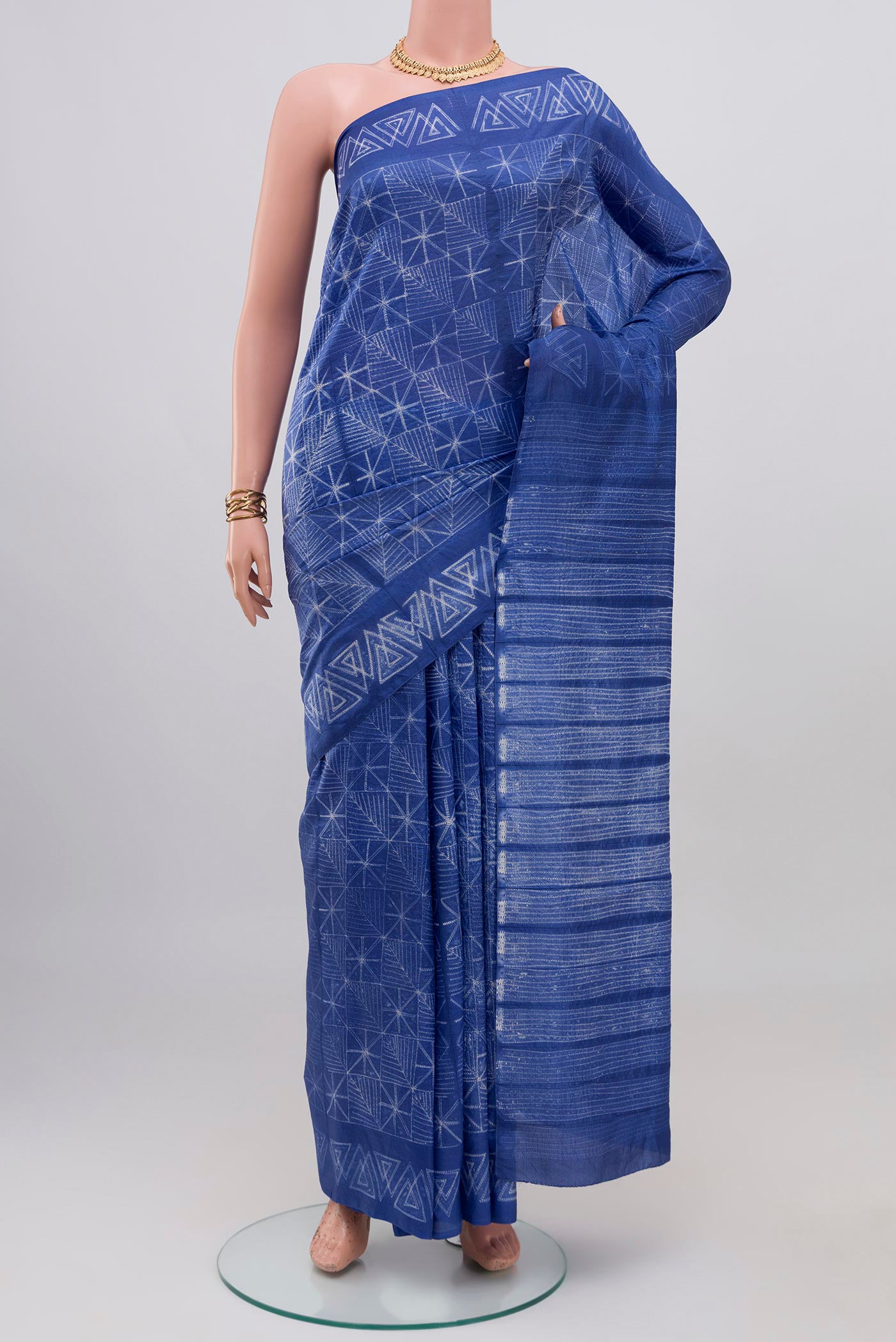 Royal Blue Tussar Silk Saree with Printed design on the body and Printed Border.  displayed on a mannequin