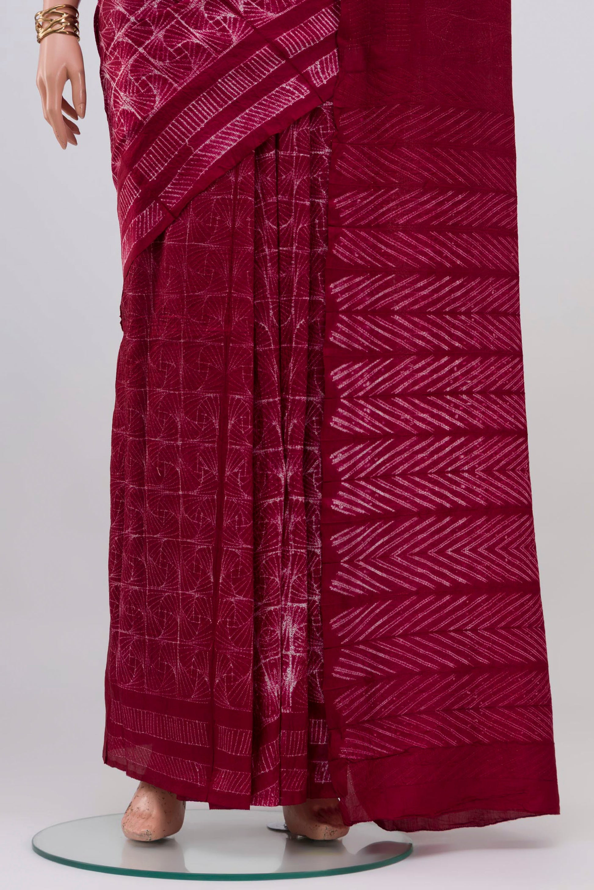 Pleats and pallu of Maroon Tussar Silk Saree with Printed design on the body and Printed Border. 