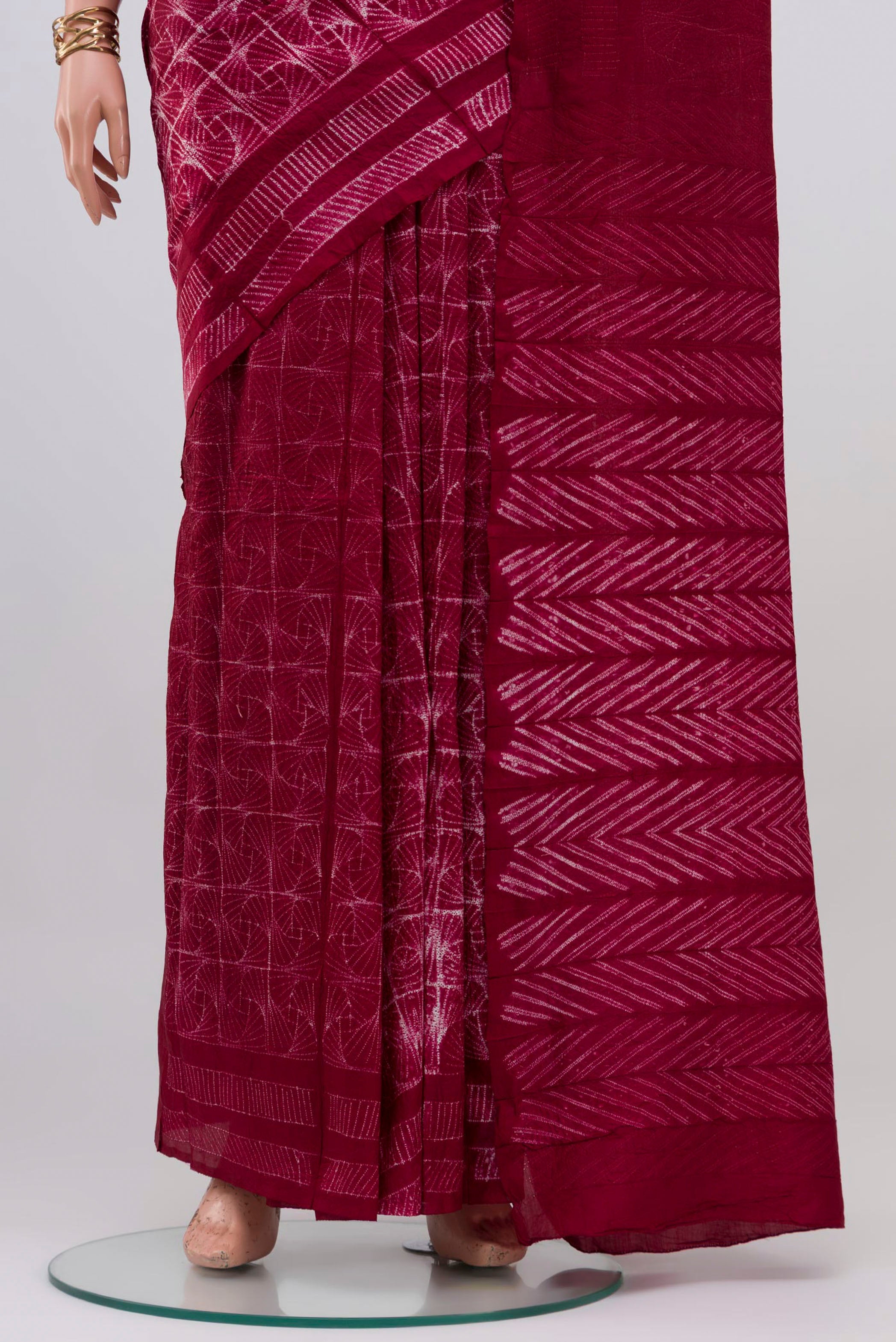 Pleats and pallu of Maroon Tussar Silk Saree with Printed design on the body and Printed Border. 