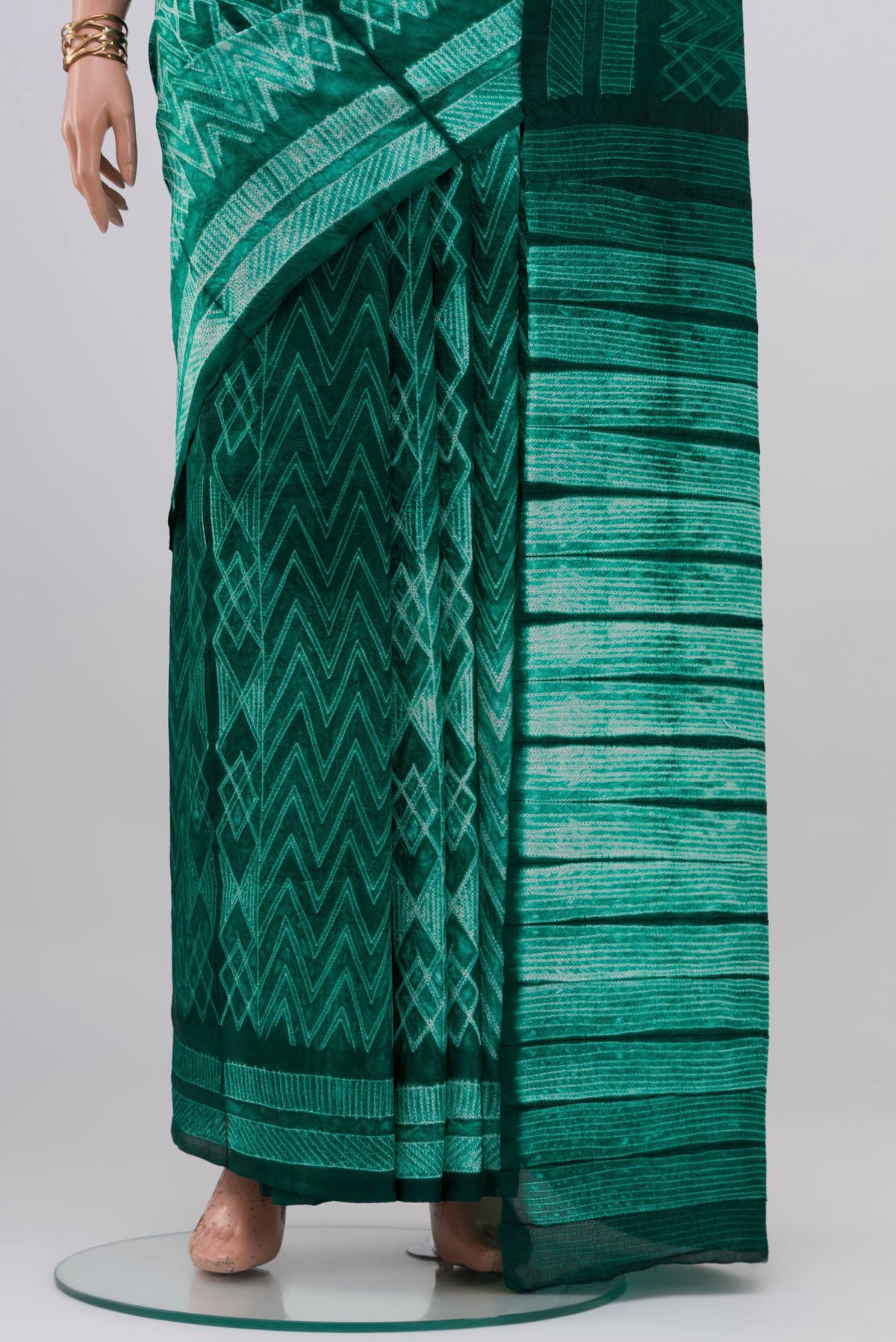 Pleats and pallu of Green Tussar Silk Saree with Printed design on the body and Printed Border. 