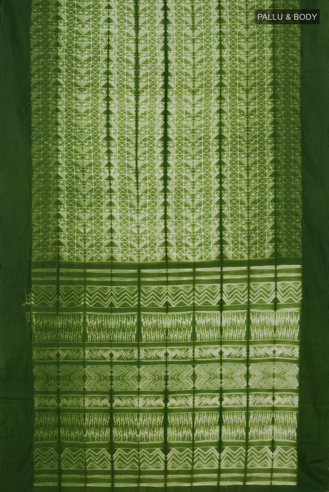 Flat view of Green Tussar Silk Saree with Printed design on the body and Plain Border. 