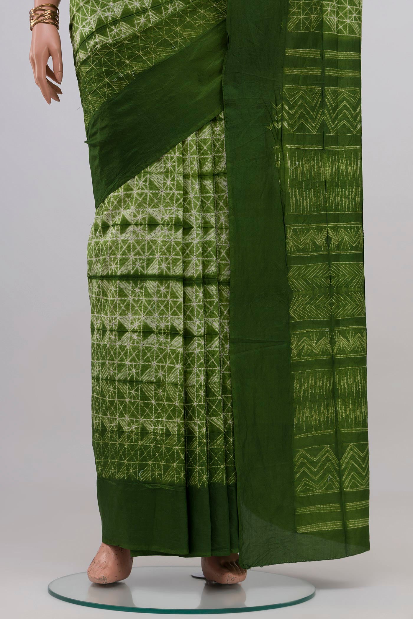 Pleats and pallu of Green Tussar Silk Saree with Printed design on the body and Plain Border. 