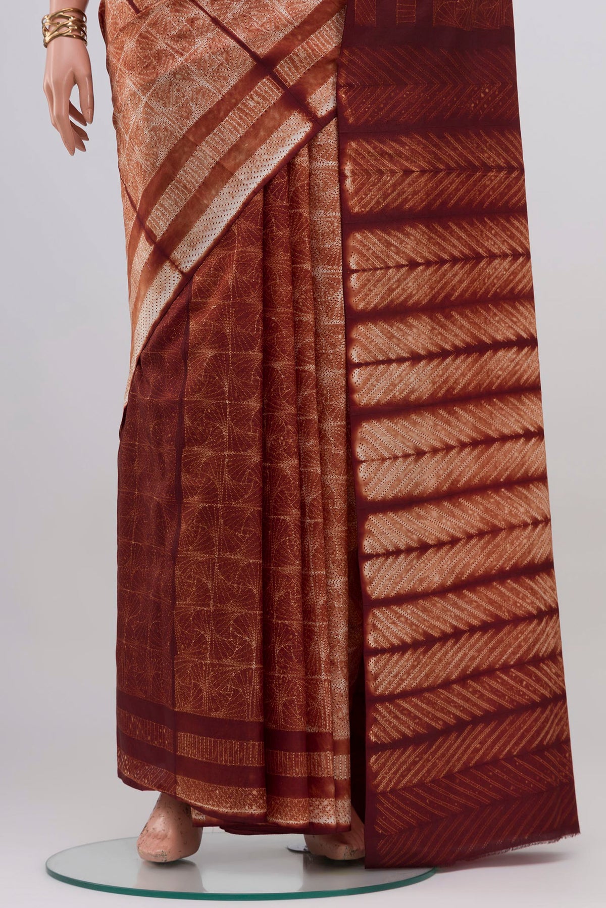 Pleats and pallu of Brown Tussar Silk Saree with Printed design on the body and Without Border. 