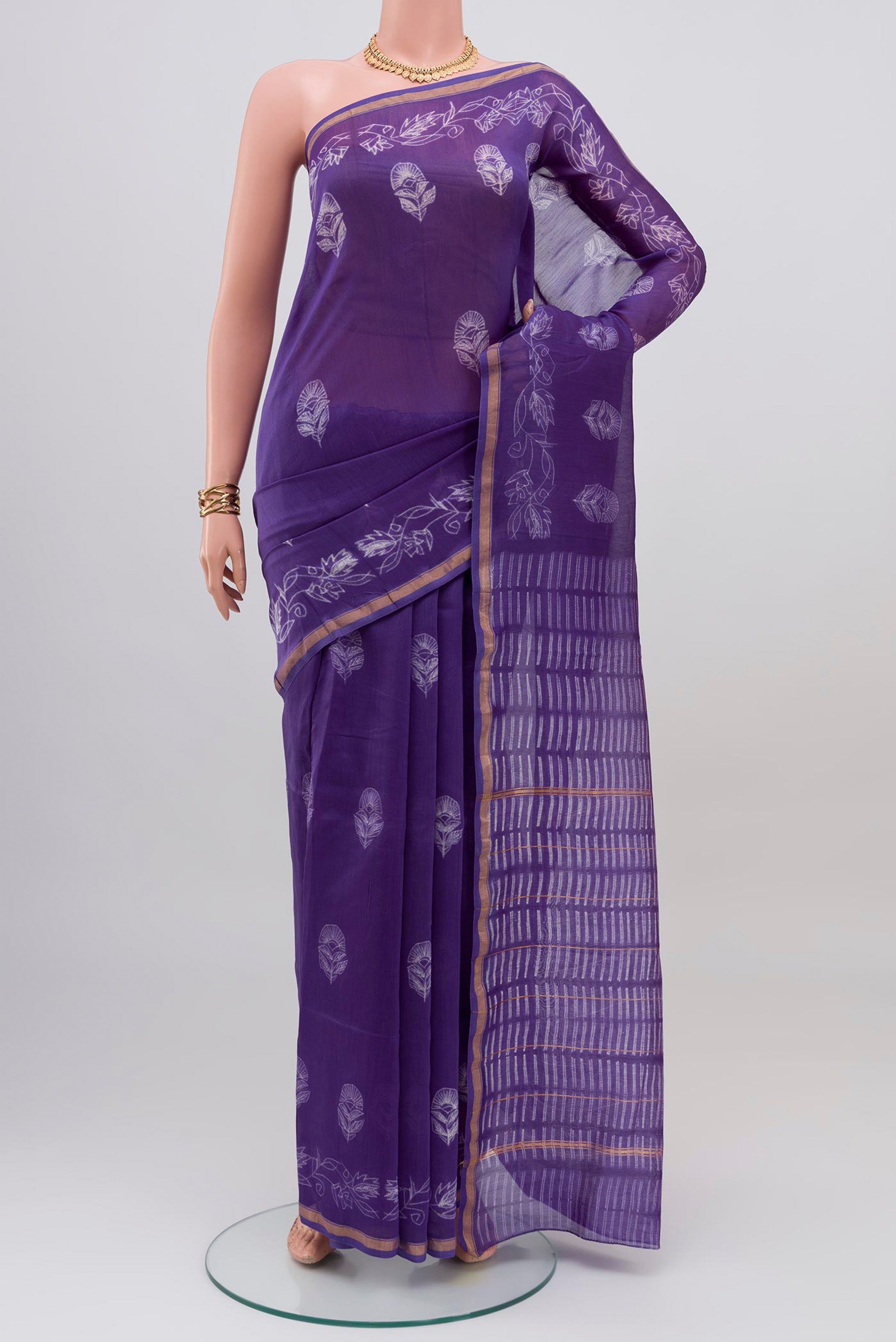Violet Chanderi Silk Cotton Saree with Printed design on the body and Thin Zari Line.  displayed on a mannequin