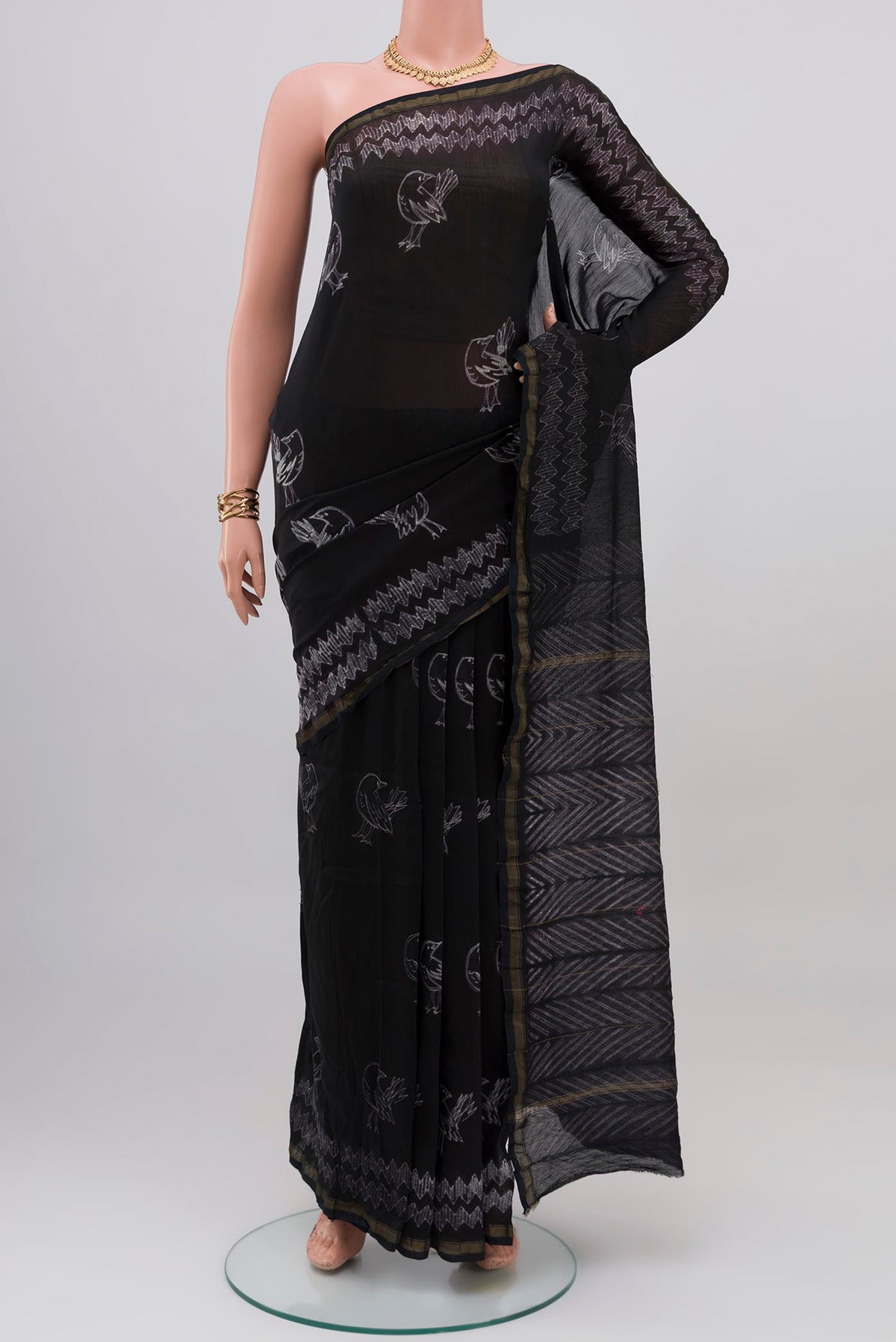 Black Chanderi Silk Cotton Saree with Printed design on the body and Thin Zari Line.  displayed on a mannequin