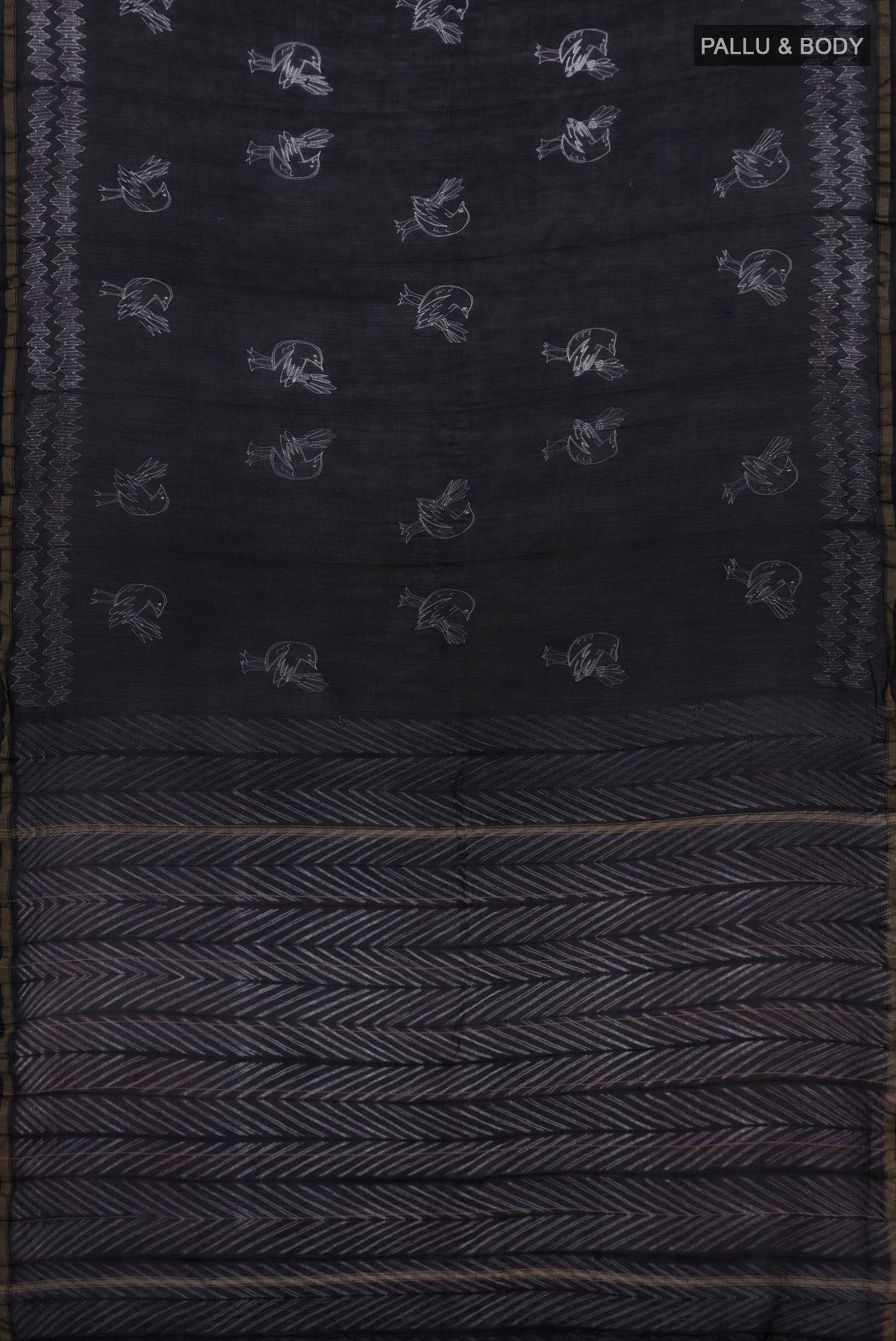 Flat view of Black Chanderi Silk Cotton Saree with Printed design on the body and Thin Zari Line. 