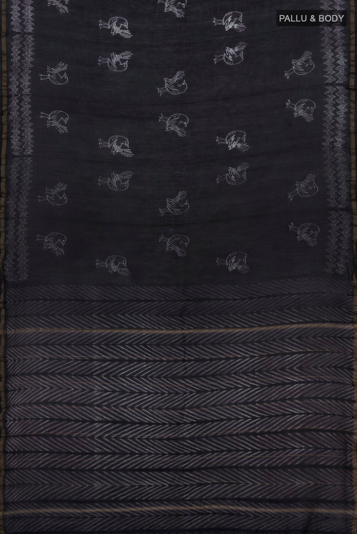 Flat view of Black Chanderi Silk Cotton Saree with Printed design on the body and Thin Zari Line. 
