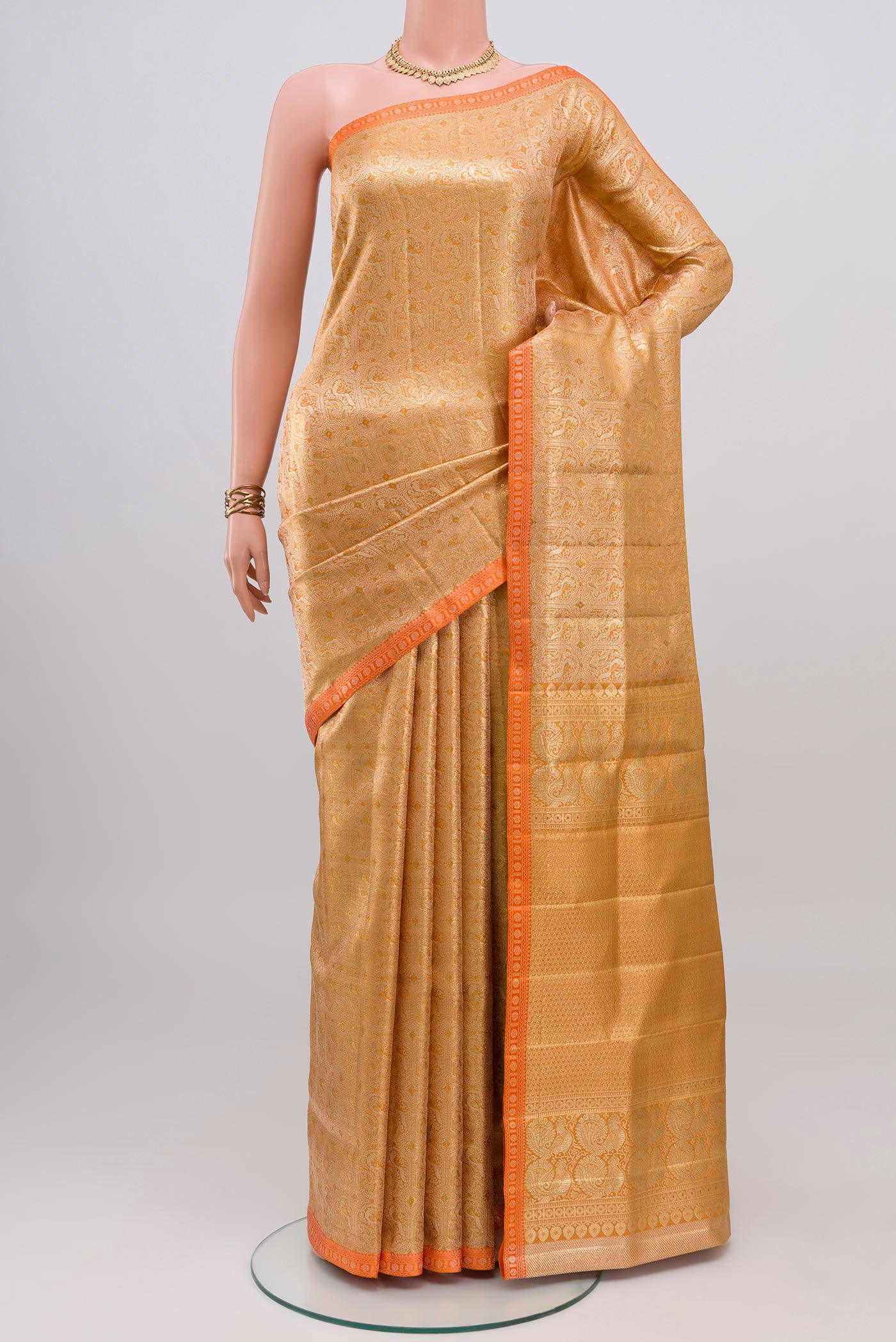 Golden Dual Tone Kanjivaram Silk Saree with Zari Brocade on the body and Thin Zari Line.  displayed on a mannequin