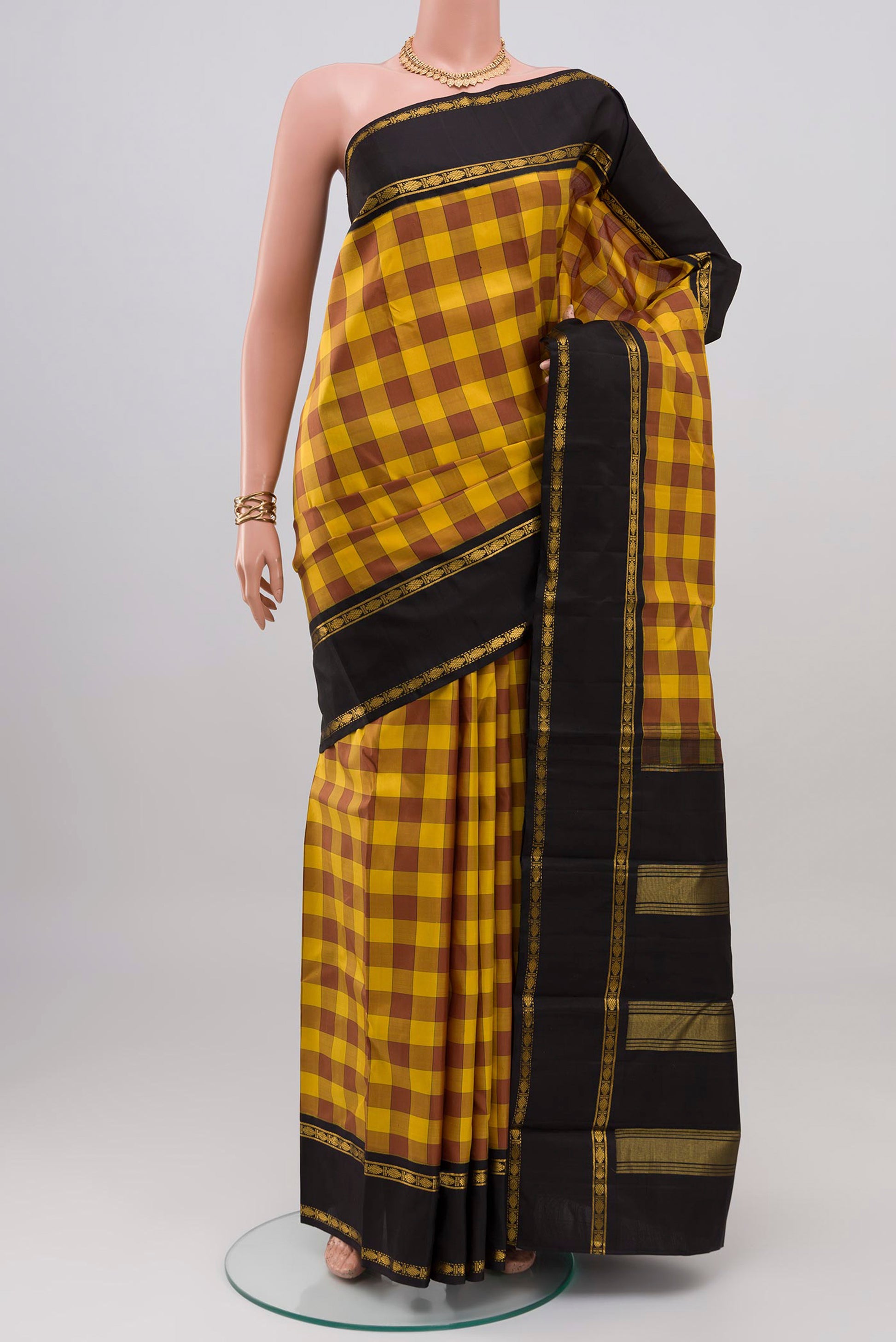 Multi Color Kanjivaram Silk Saree with Checked design on the body and Zari Border.  displayed on a mannequin