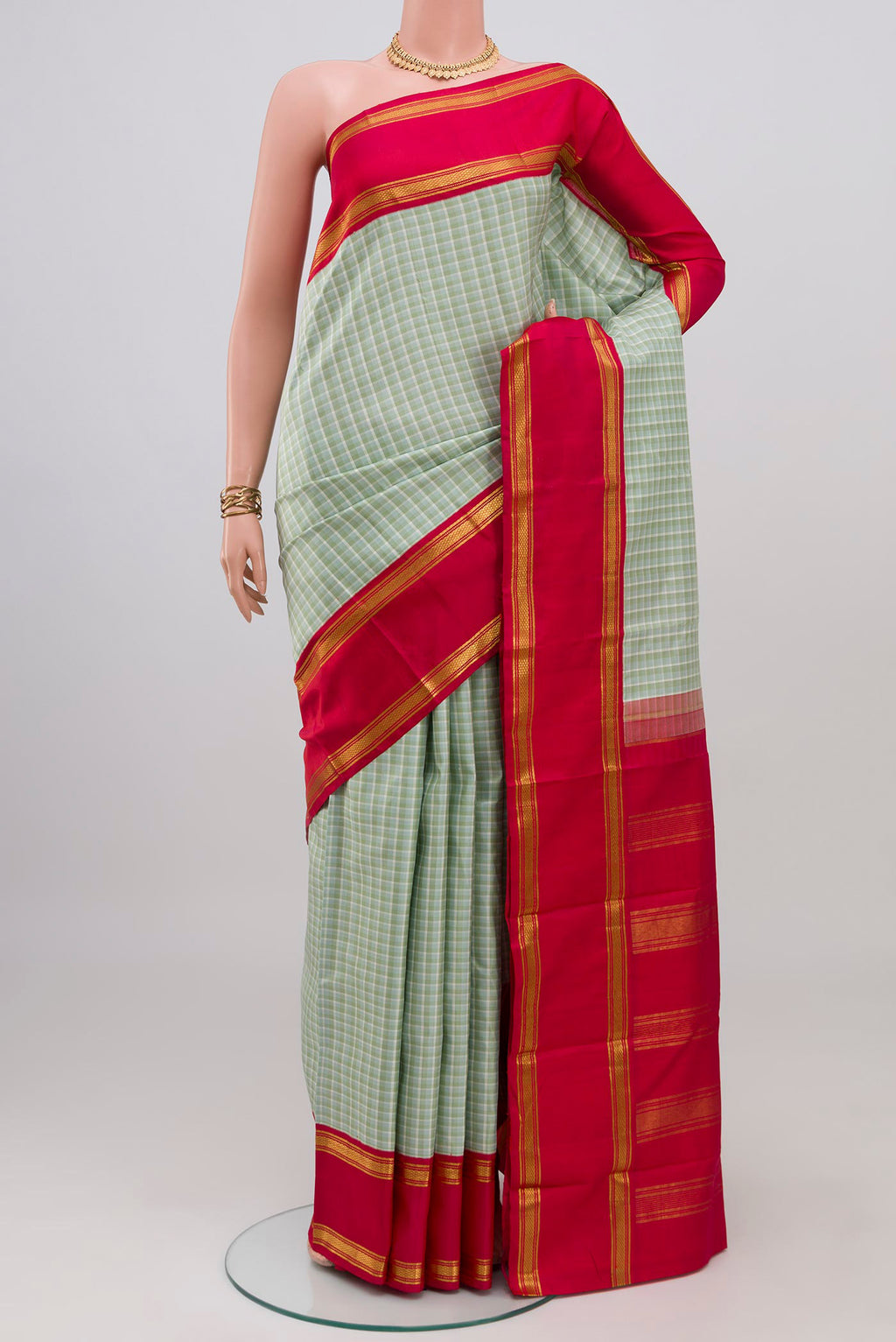 Multi Color Kanjivaram Silk Saree with Checked design on the body and Plain Border.  displayed on a mannequin
