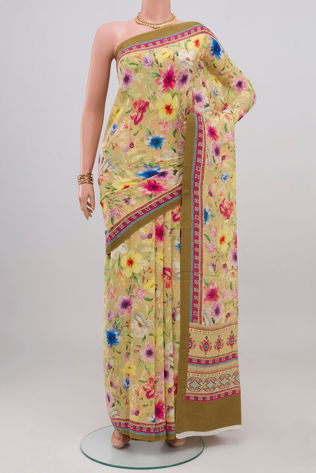 Beige Crepe Saree with Printed design on the body and Printed Border.  displayed on a mannequin