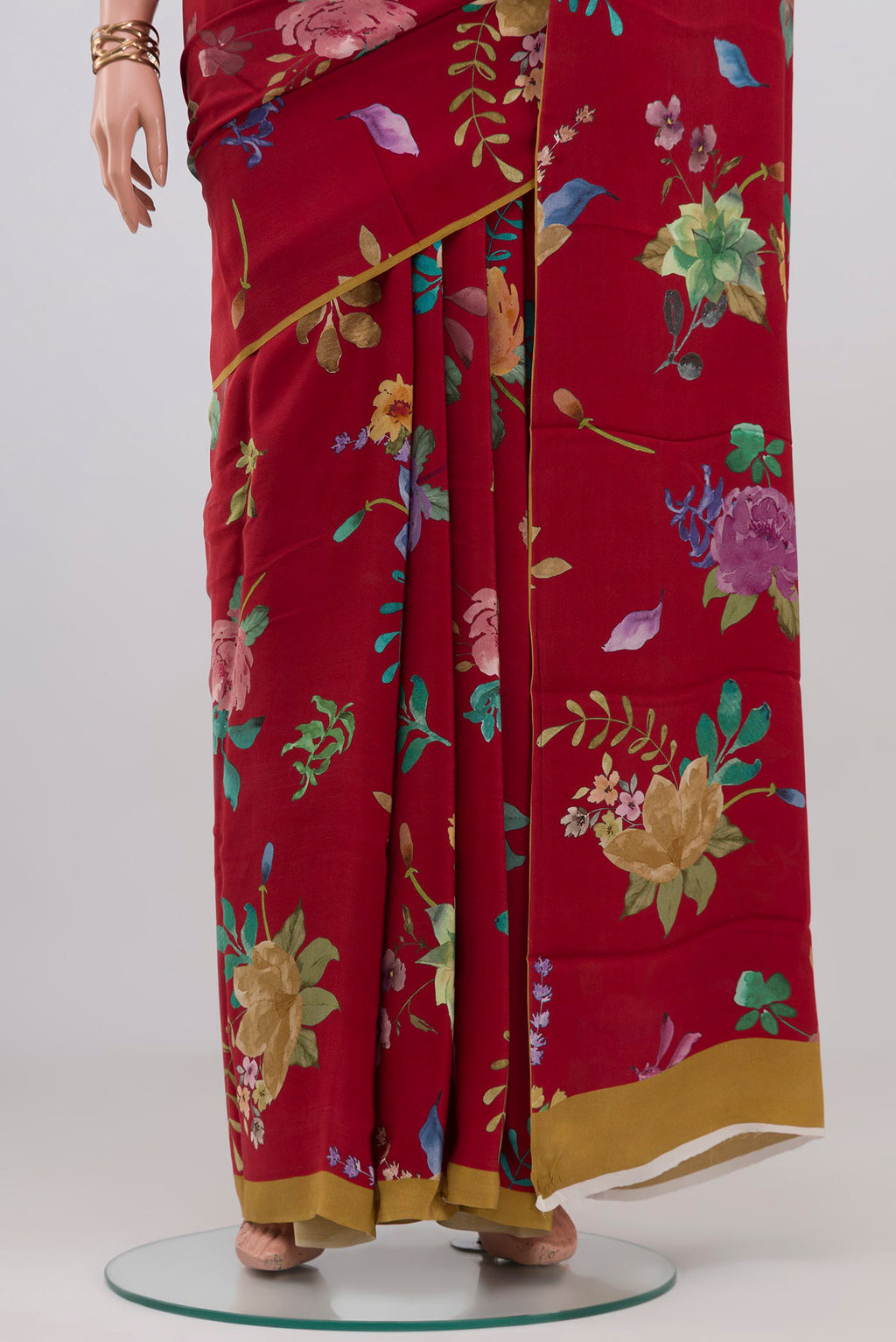 Pleats and pallu of Red Crepe Saree with Floral Print on the body and Without Border. 