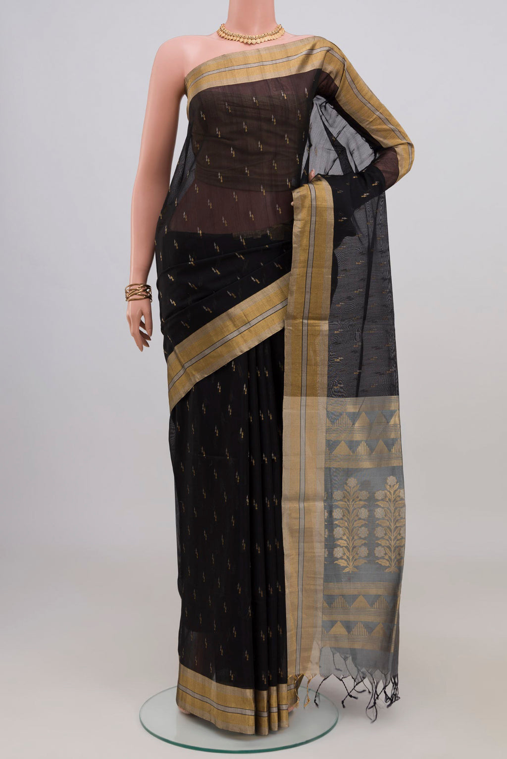 Black Silk Cotton Saree with Zari Butta on the body and Zari Border.  displayed on a mannequin
