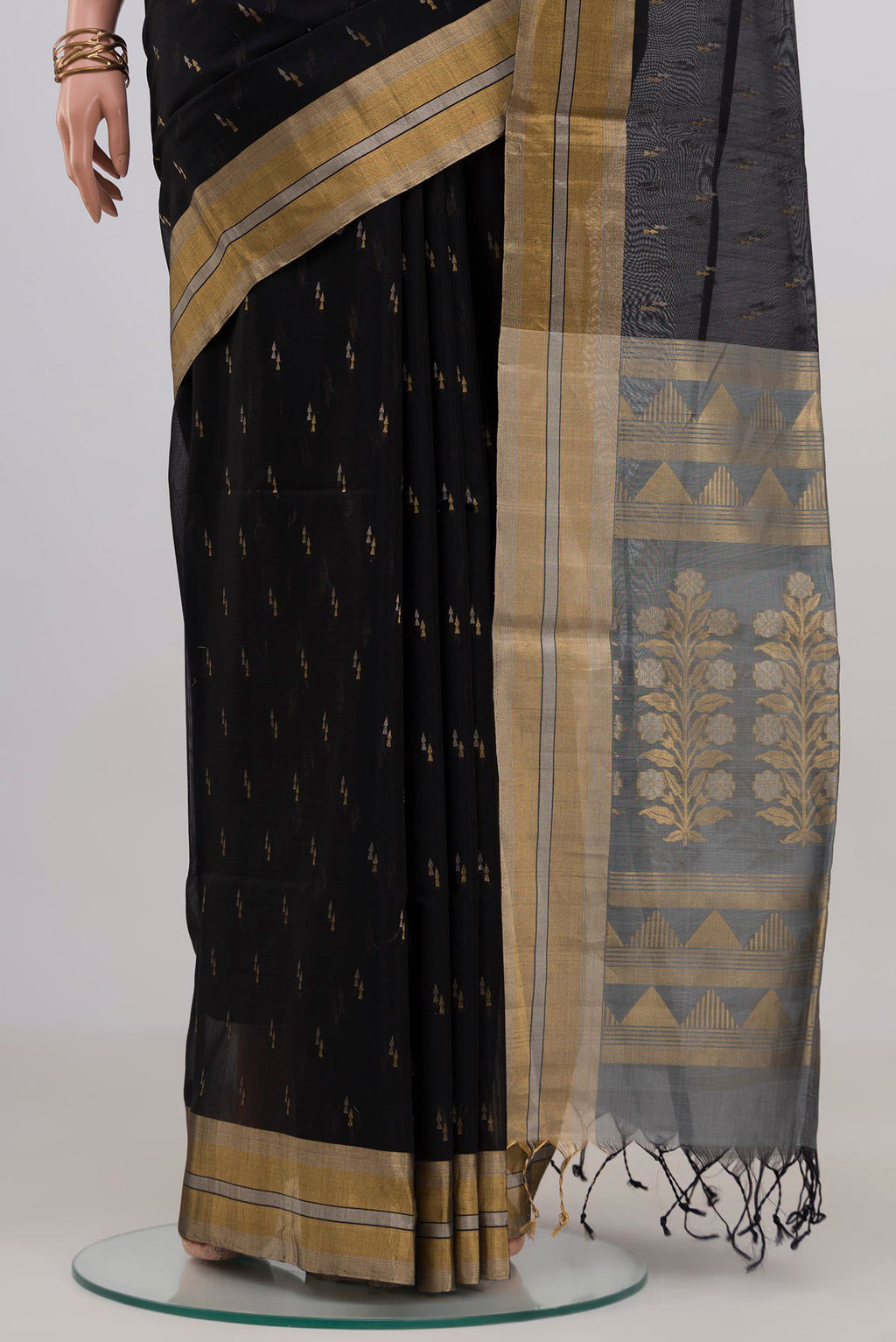 Pleats and pallu of Black Silk Cotton Saree with Zari Butta on the body and Zari Border. 
