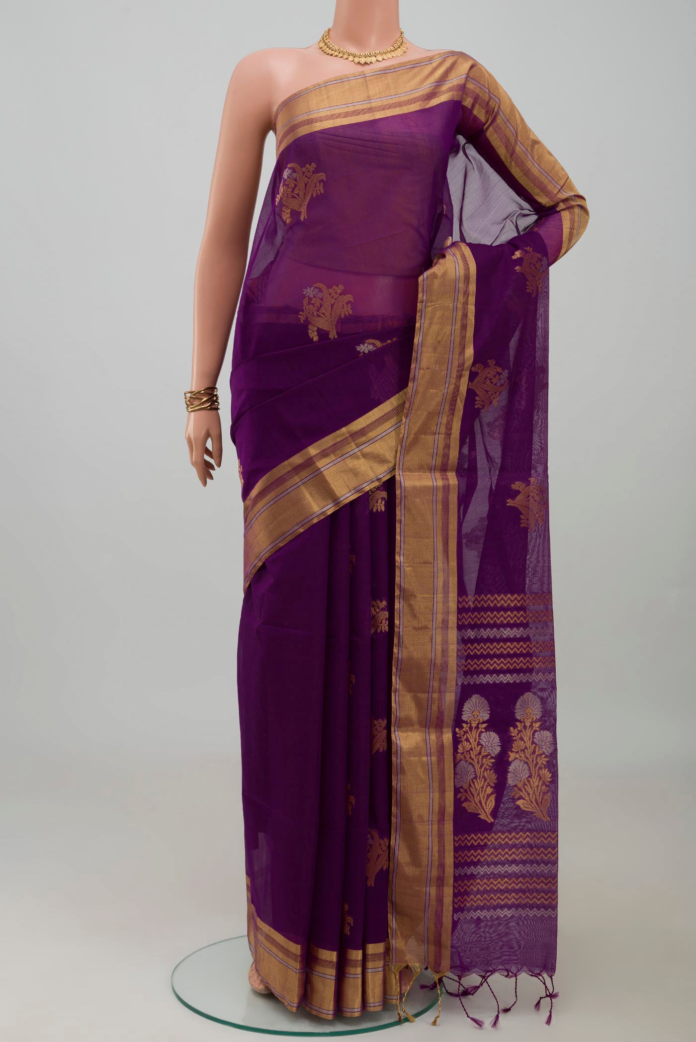 Purple Silk Cotton Saree with Zari Butta on the body and Zari Border.  displayed on a mannequin