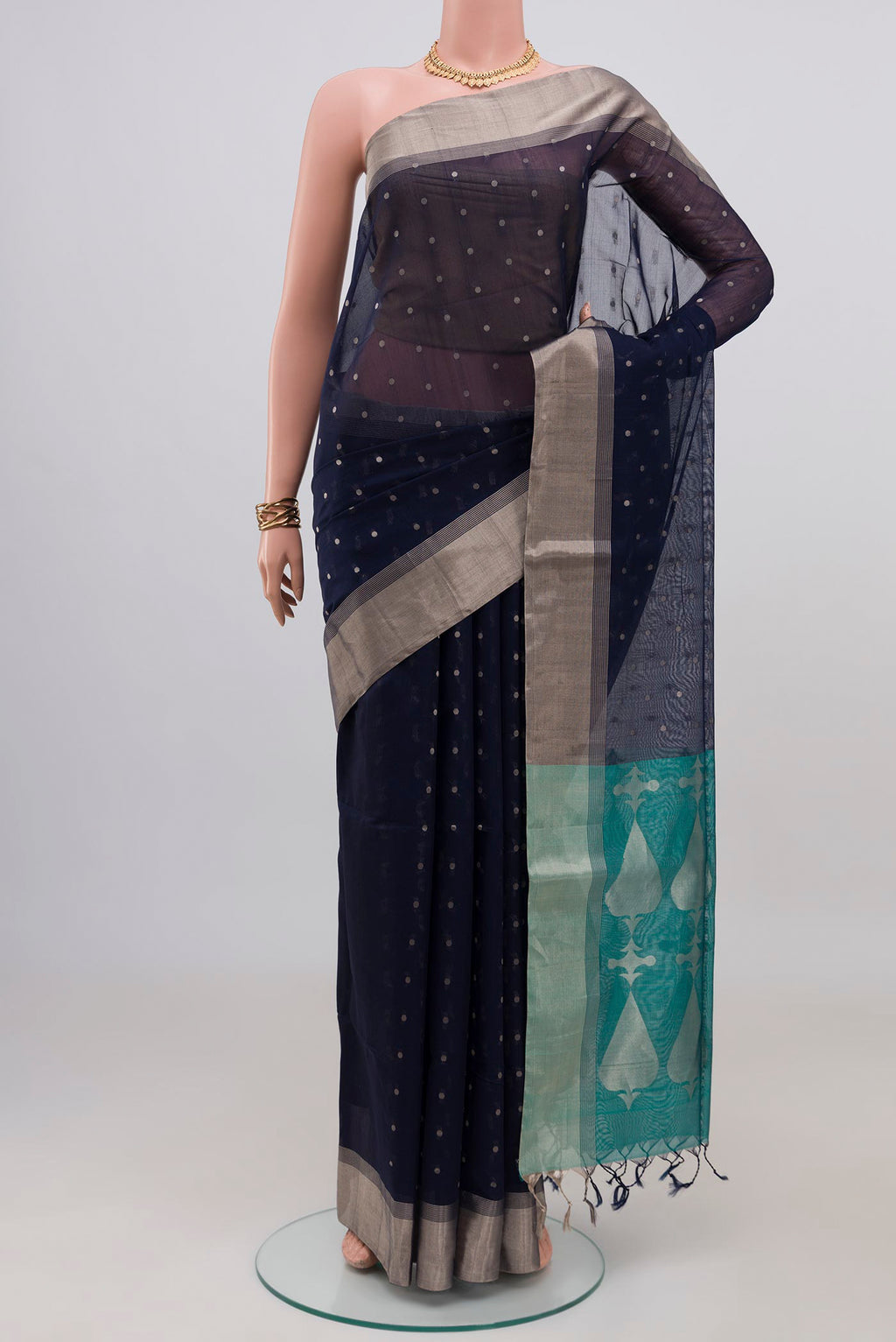 Navy Blue Silk Cotton Saree with Zari Butta on the body and Zari Border.  displayed on a mannequin