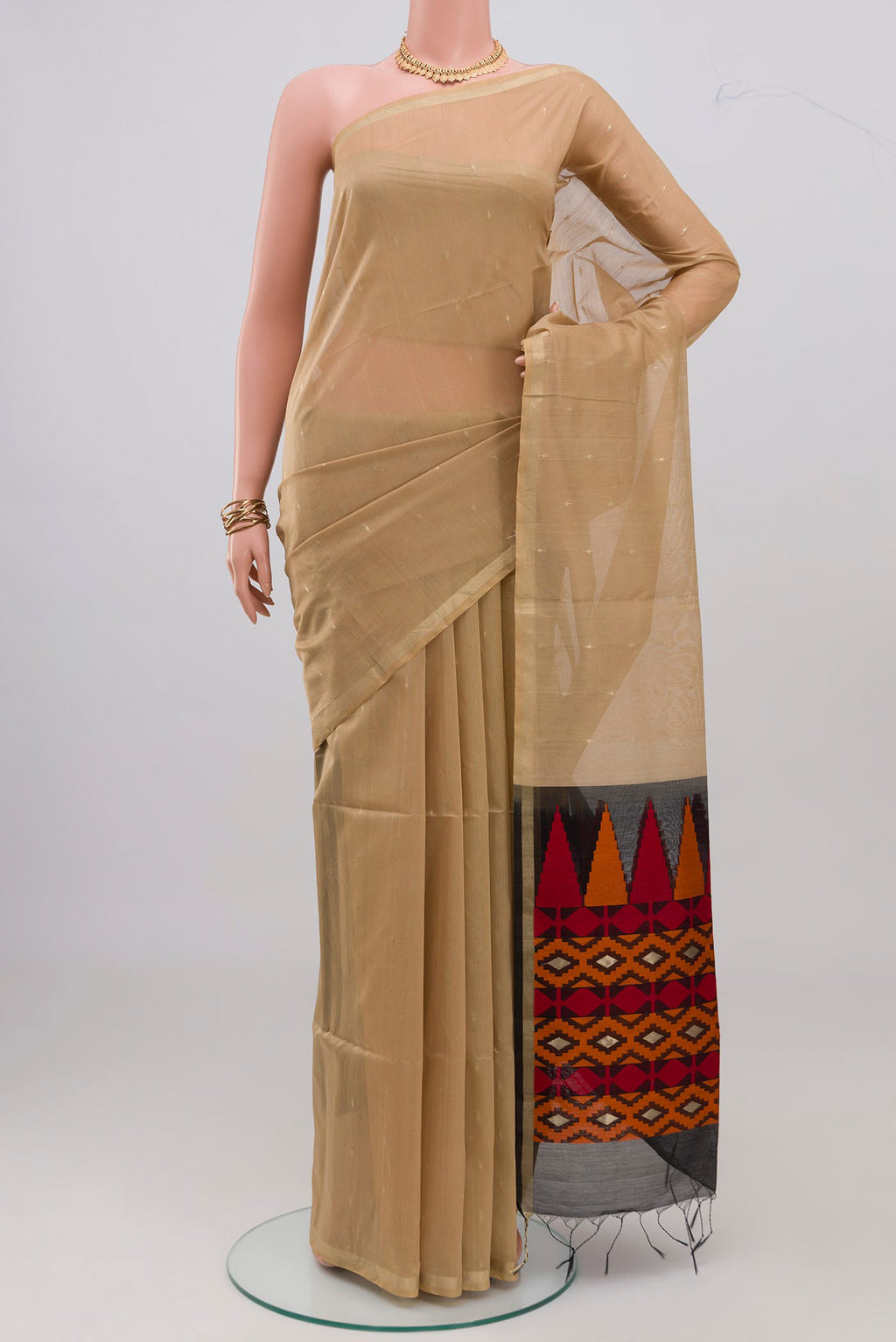 Beige Silk Cotton Saree with Zari Butta on the body and Zari Border.  displayed on a mannequin
