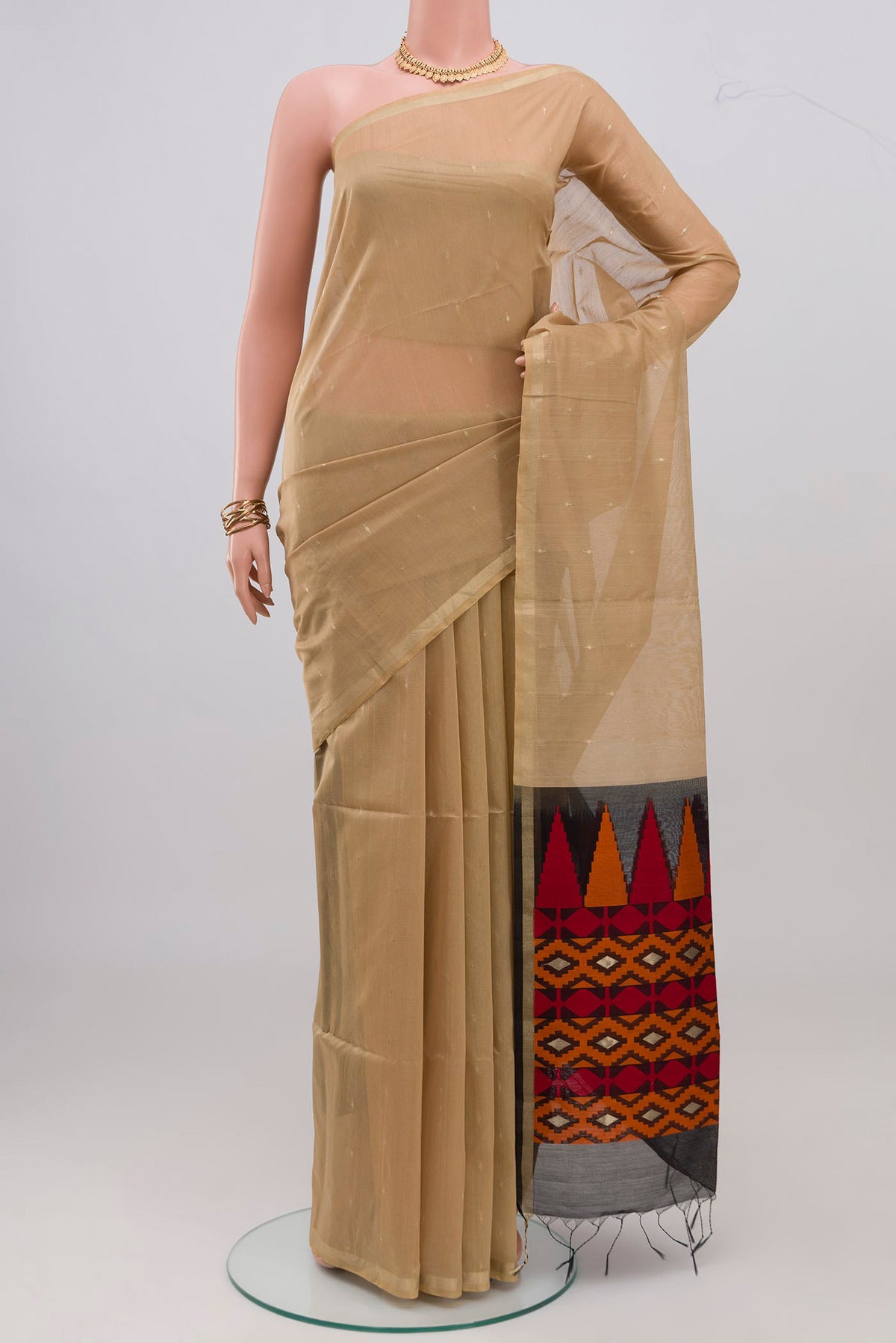 Beige Silk Cotton Saree with Zari Butta on the body and Zari Border.  displayed on a mannequin