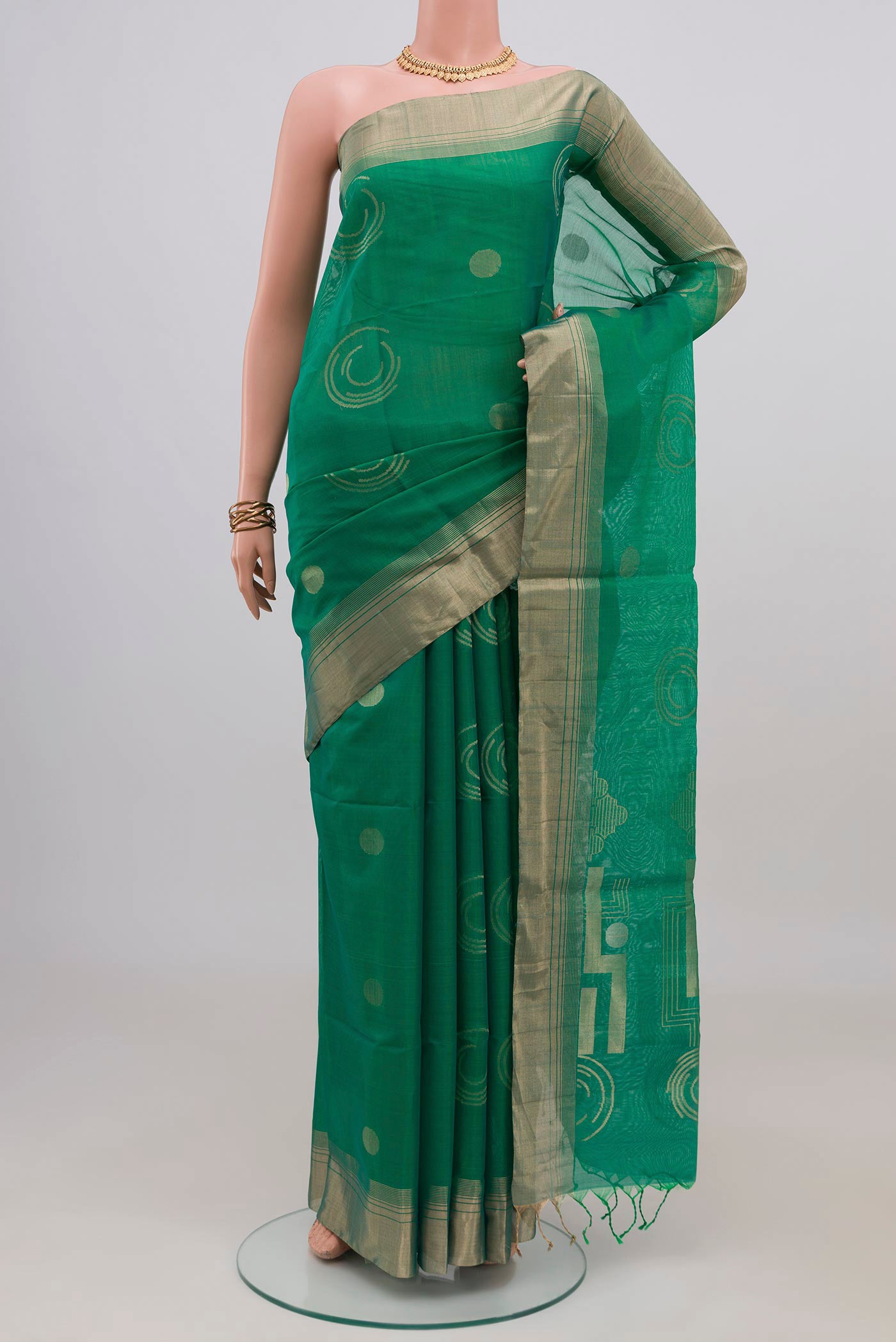 Teal Silk Cotton Saree with Zari Butta on the body and Zari Border.  displayed on a mannequin
