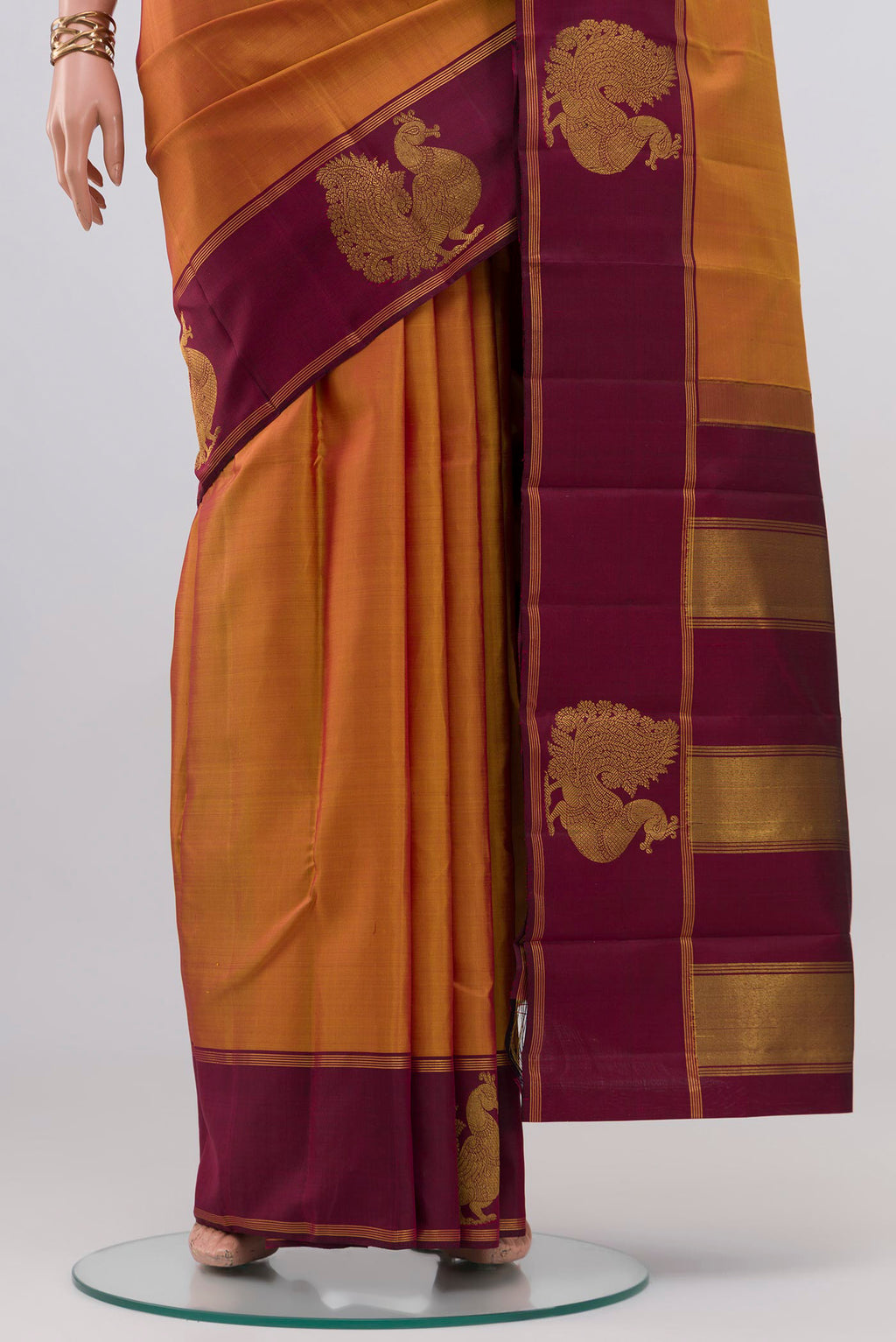 Pleats and pallu of Mustard Kanchipuram Silk Saree with Plain Body and Fancy Border. 