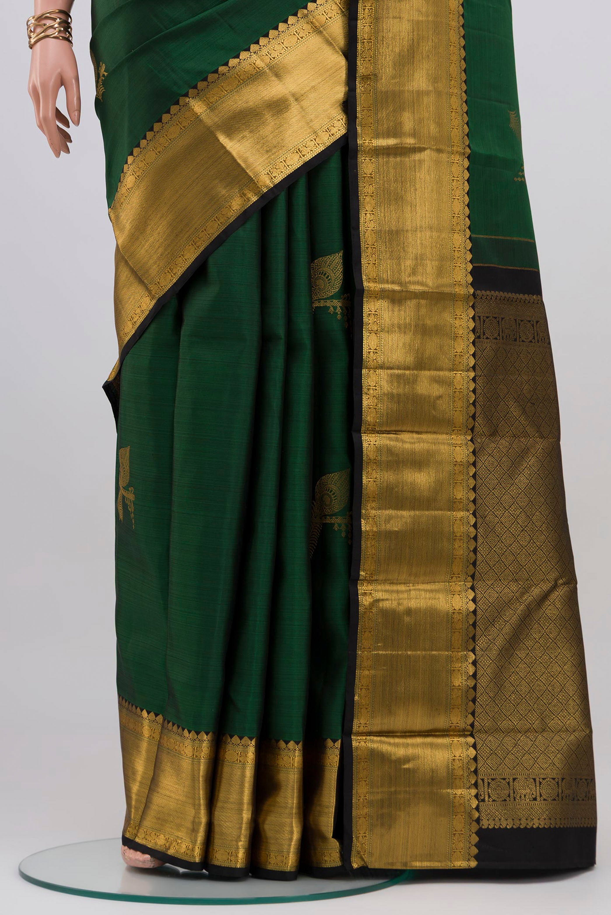 Pleats and pallu of Bottle Green Kanjivaram Silk Saree with Zari Butta on the body and Zari Border. 