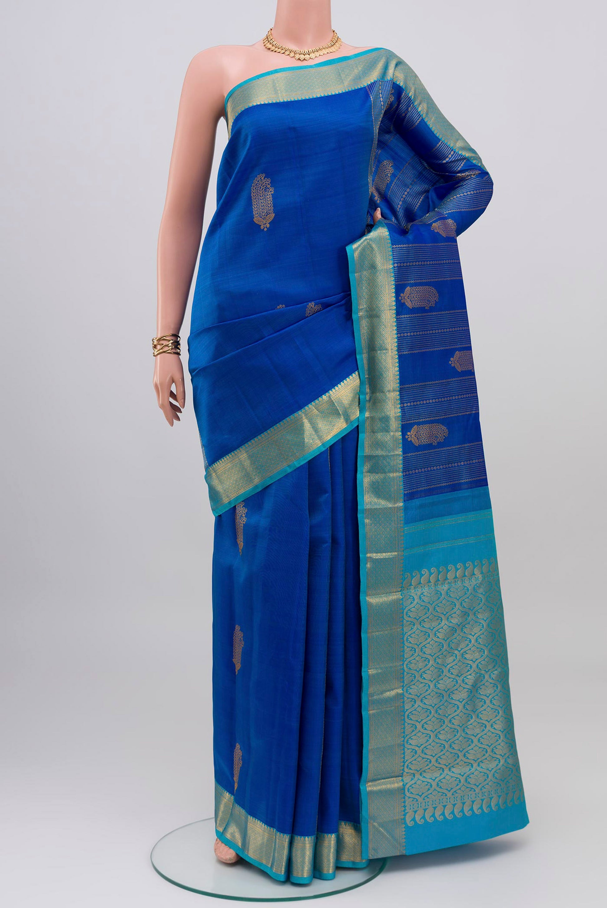 Royal Blue Kanjivaram Silk Saree with Zari Butta on the body and Zari Border.  displayed on a mannequin