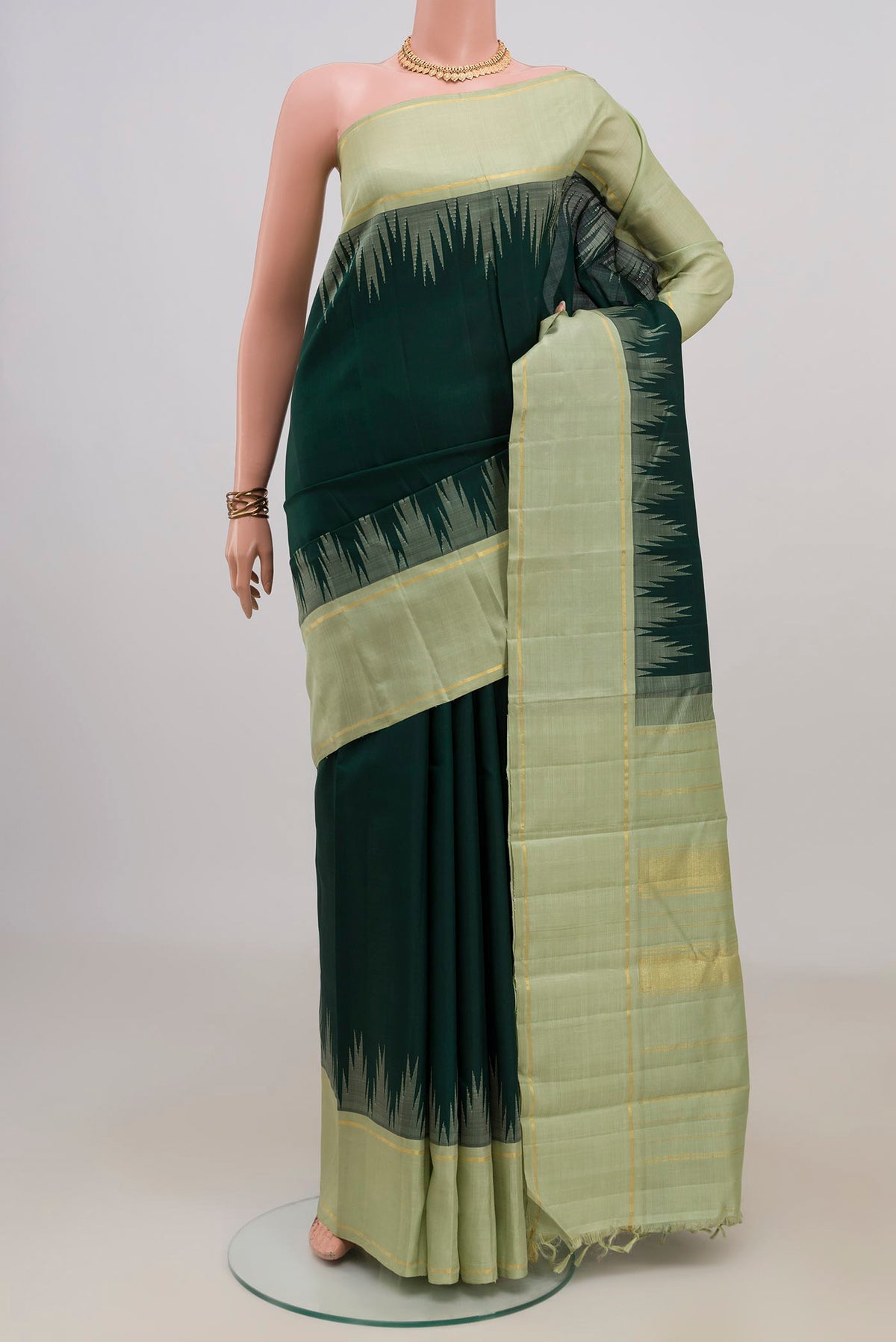 Pure Silk Bottle Green Kanjivaram Saree with Plain Body and Temple Border.  displayed on a mannequin