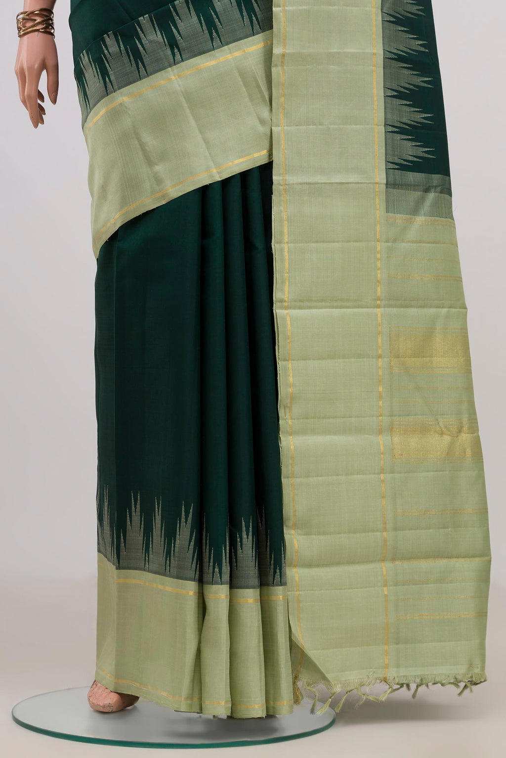 Pleats and pallu of Pure Silk Bottle Green Kanjivaram Saree with Plain Body and Temple Border. 