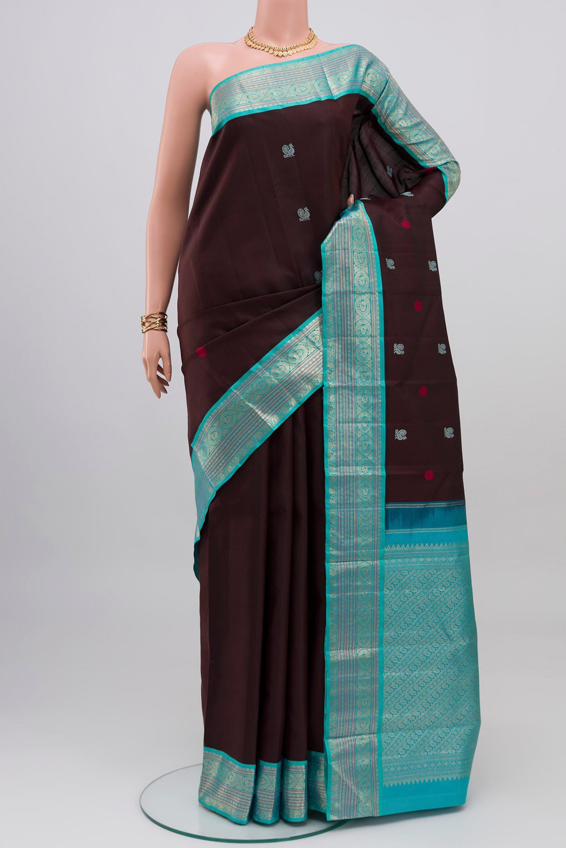 Coffee Brown Kanjivaram Silk Saree with Thread Butta on the body and Zari Border.  displayed on a mannequin