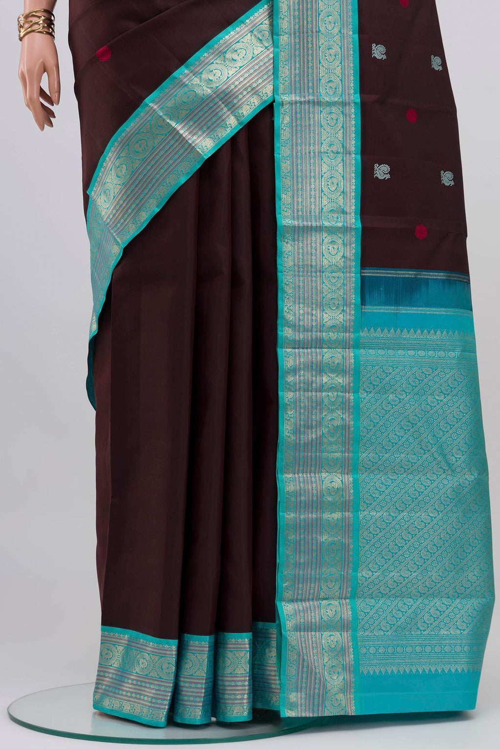 Pleats and pallu of Coffee Brown Kanjivaram Silk Saree with Thread Butta on the body and Zari Border. 