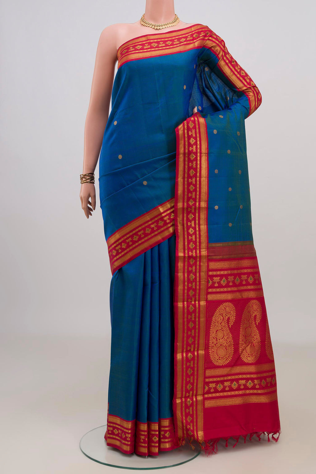 Pure Silk Blue Kanjivaram Saree with Zari Butta on the body and Zari Border.  displayed on a mannequin