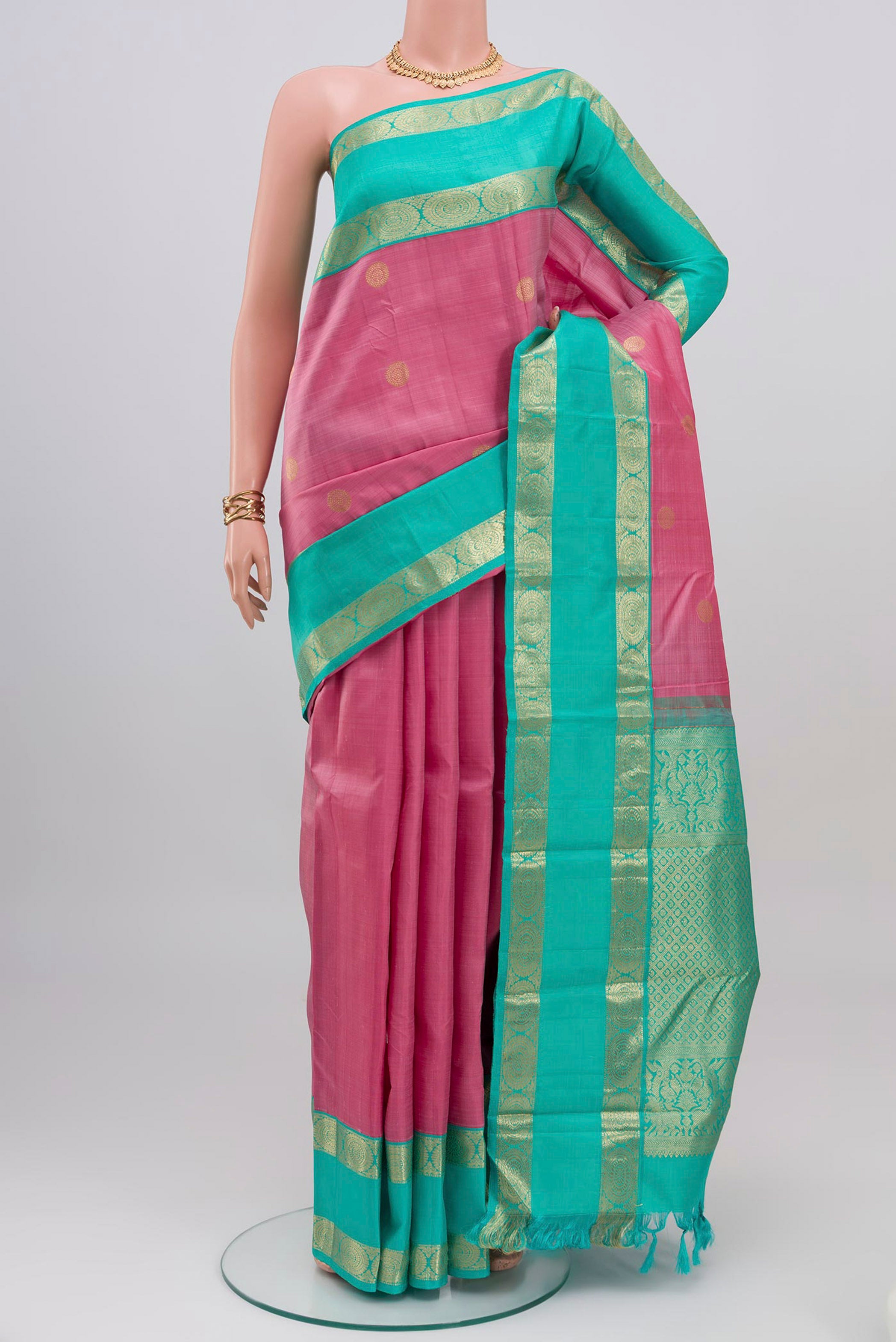 Pink Kanjivaram Silk Saree with Zari Butta on the body and Zari Border.  displayed on a mannequin