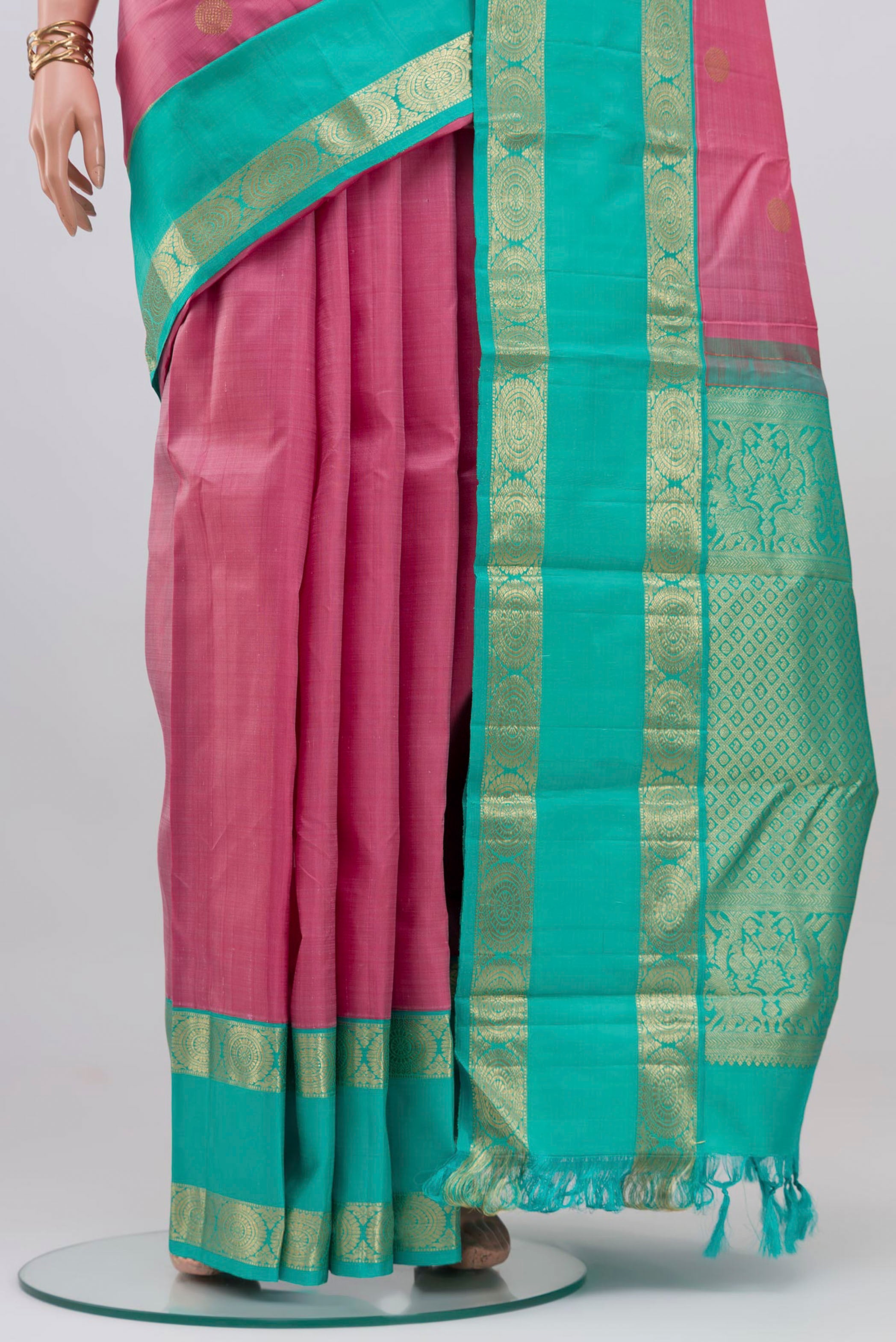 Pleats and pallu of Pink Kanjivaram Silk Saree with Zari Butta on the body and Zari Border. 