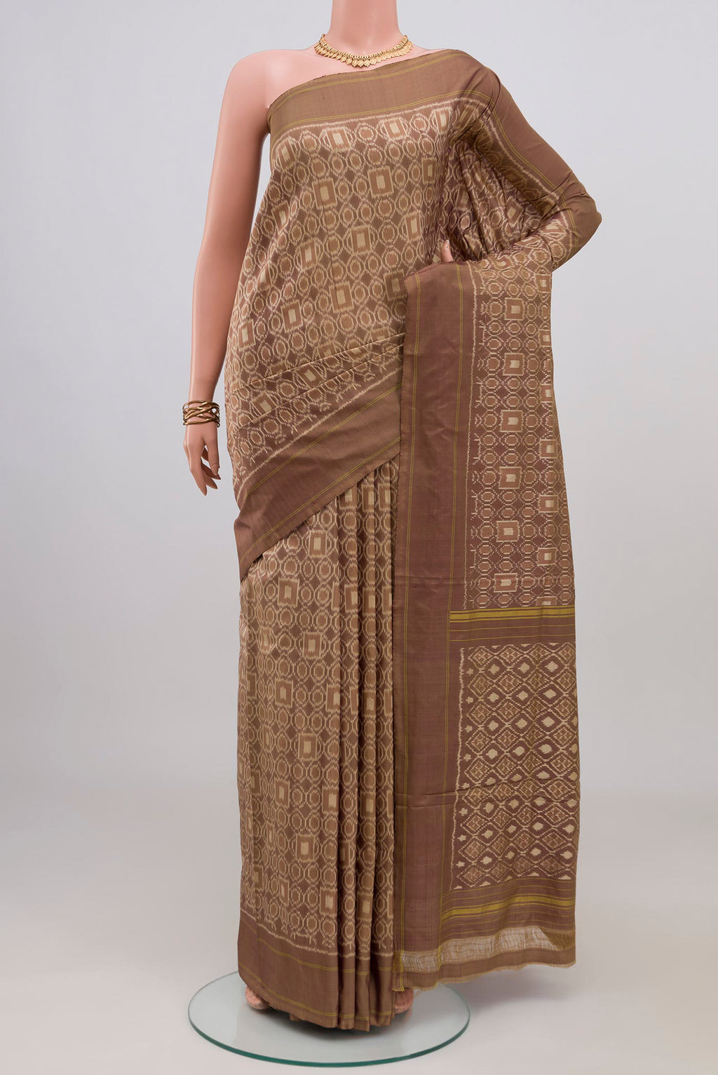 Brown Pochampally Silk Saree with Ikat design on the body and Plain Border.  displayed on a mannequin