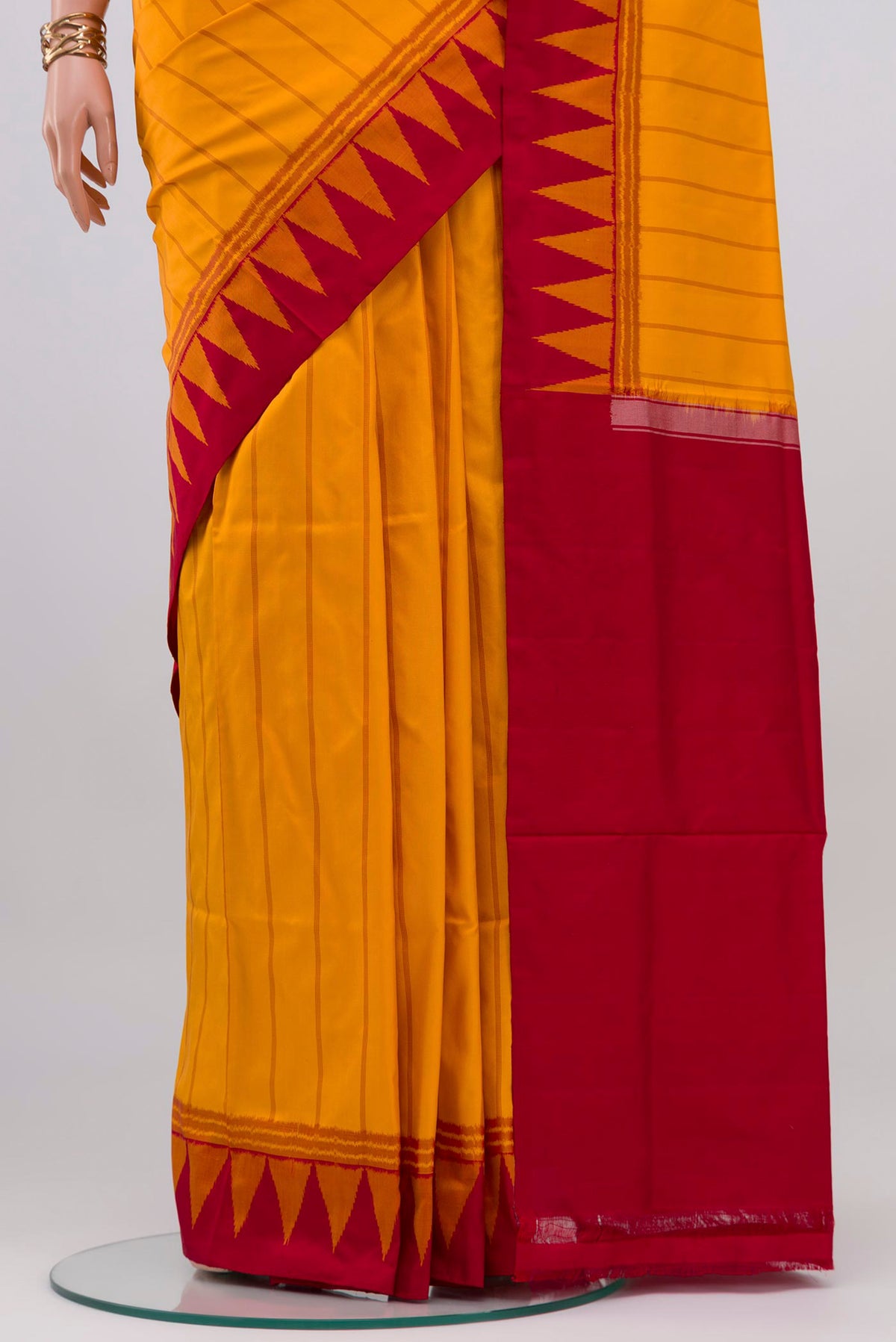 Pleats and pallu of Yellow Pochampally Silk Saree with Ikat design on the body and Temple Border. 