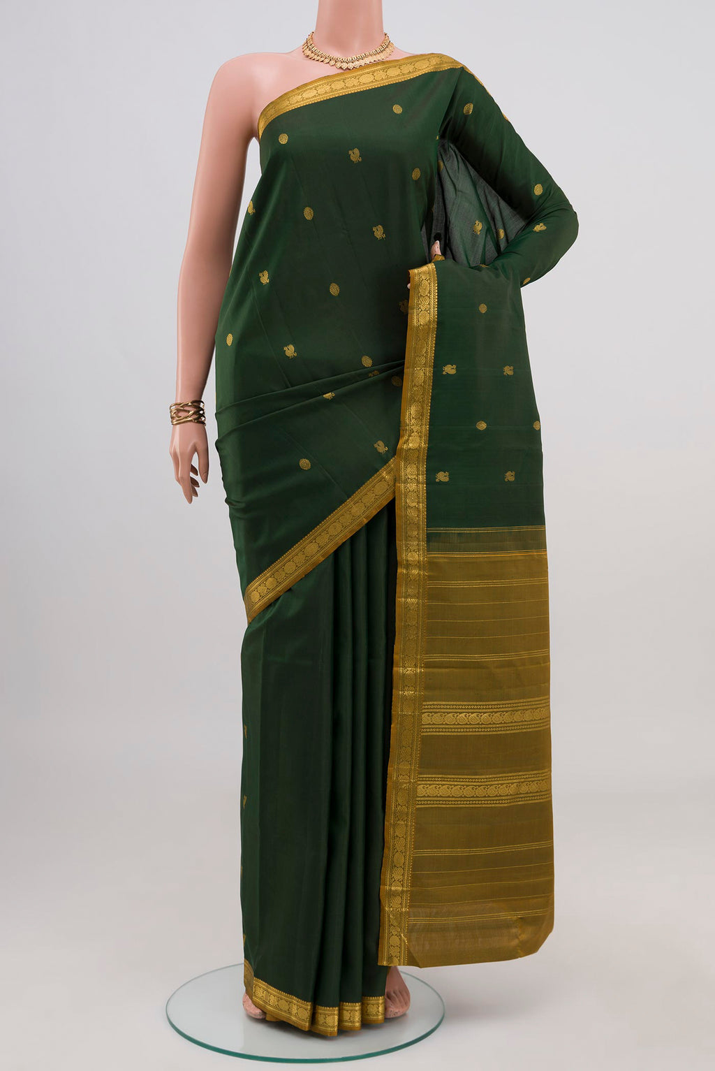 Pure Silk Pure Zari Green Kanchipuram Saree with Zari Butta on the body and Zari Border.  displayed on a mannequin