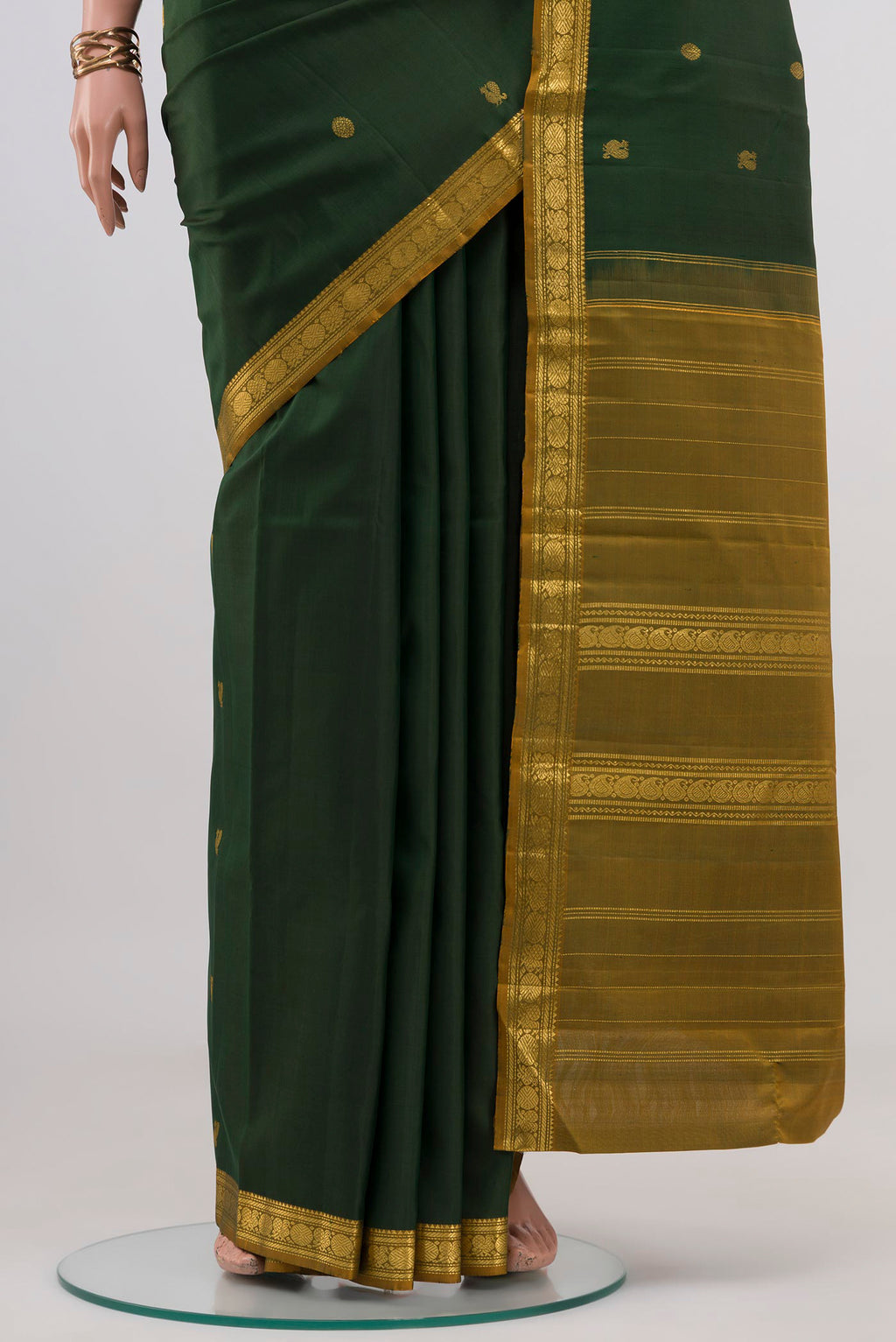 Pleats and pallu of Pure Silk Pure Zari Green Kanchipuram Saree with Zari Butta on the body and Zari Border. 