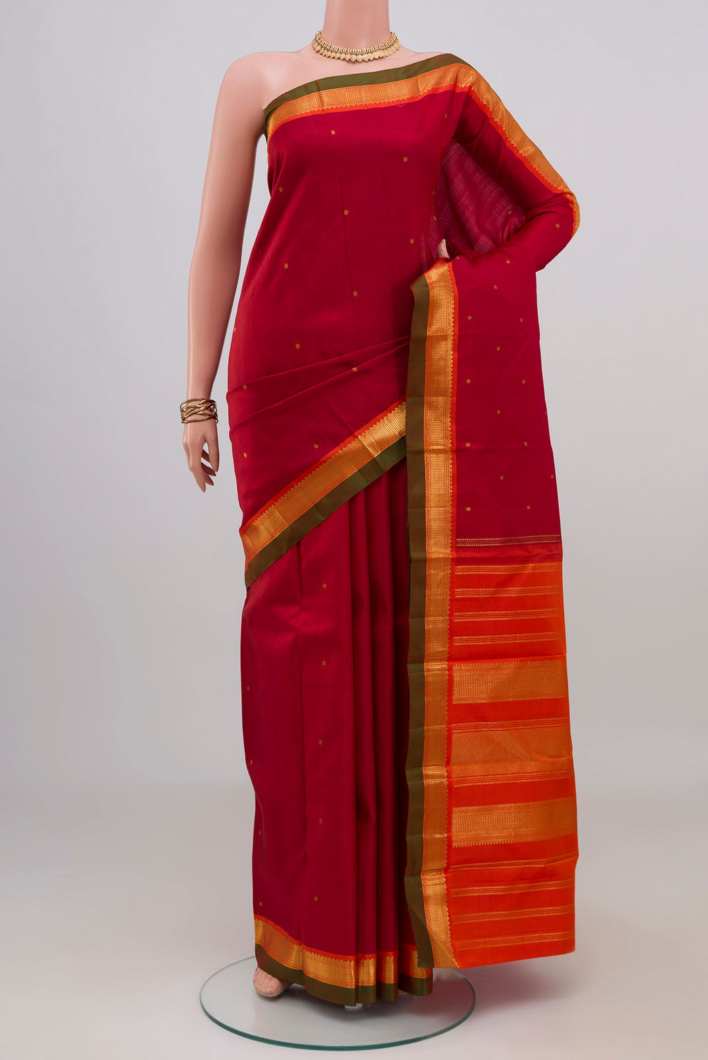 Maroon Kanchipuram Silk Saree with Zari Butta on the body and Zari Border.  displayed on a mannequin